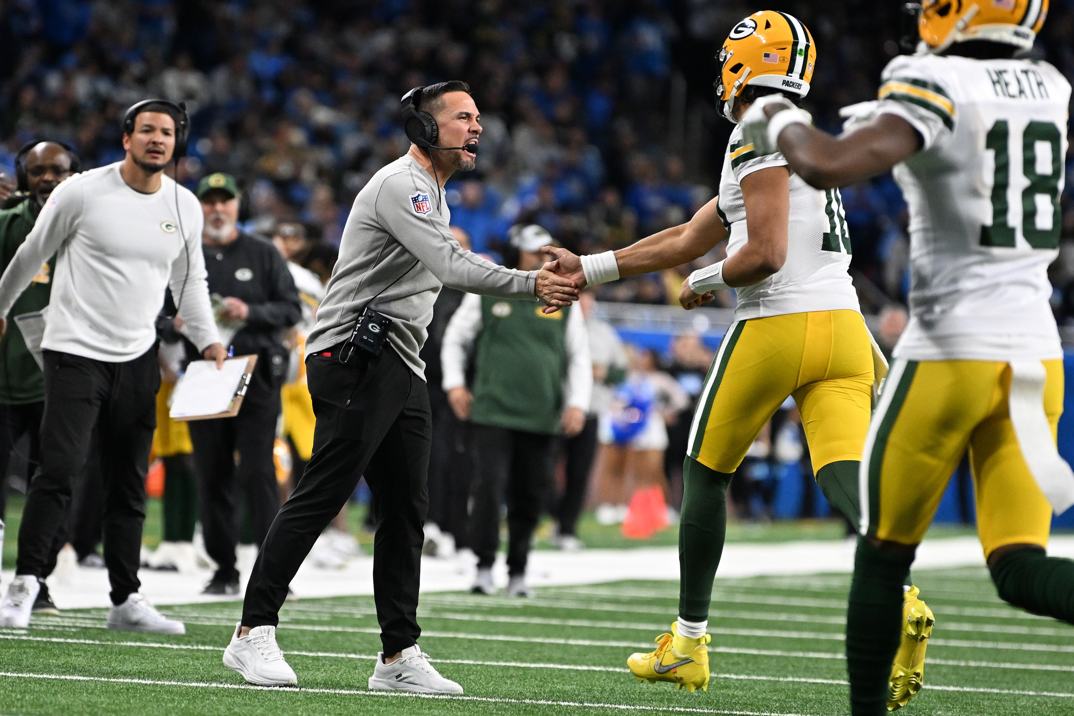 Green Bay Packers head coach Matt LeFleur celebrates withGreen Bay Packers quarterback Jordan Love (10) after Love threw a touchdown pass to tight end Tucker Kraft (not pictured) against the Detroit Lions in the third quarter at Ford Field.