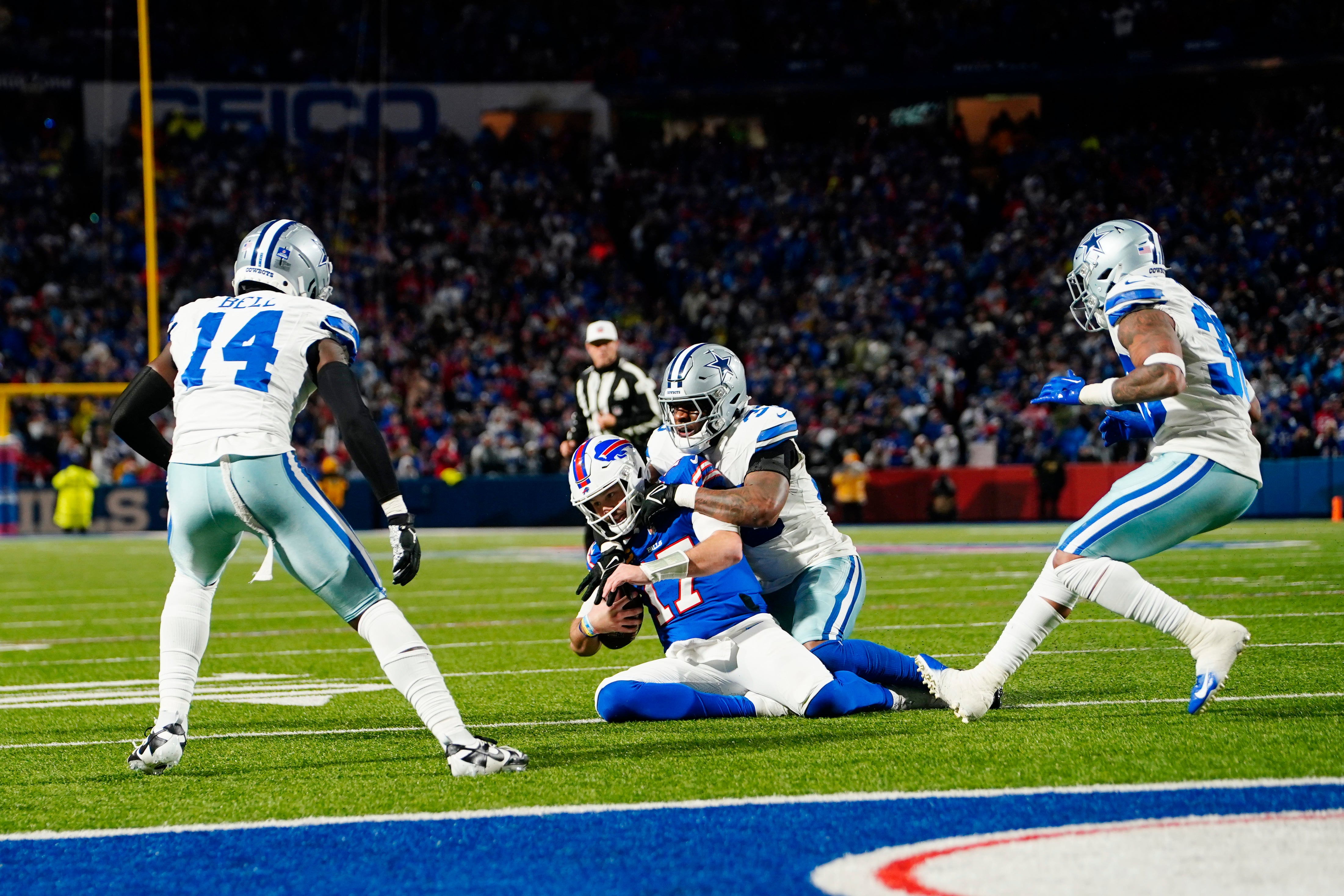 Dallas Cowboys linebacker Damone Clark (33) tackles Buffalo Bills quarterback Josh Allen (17) in the second half at Highmark Stadium.