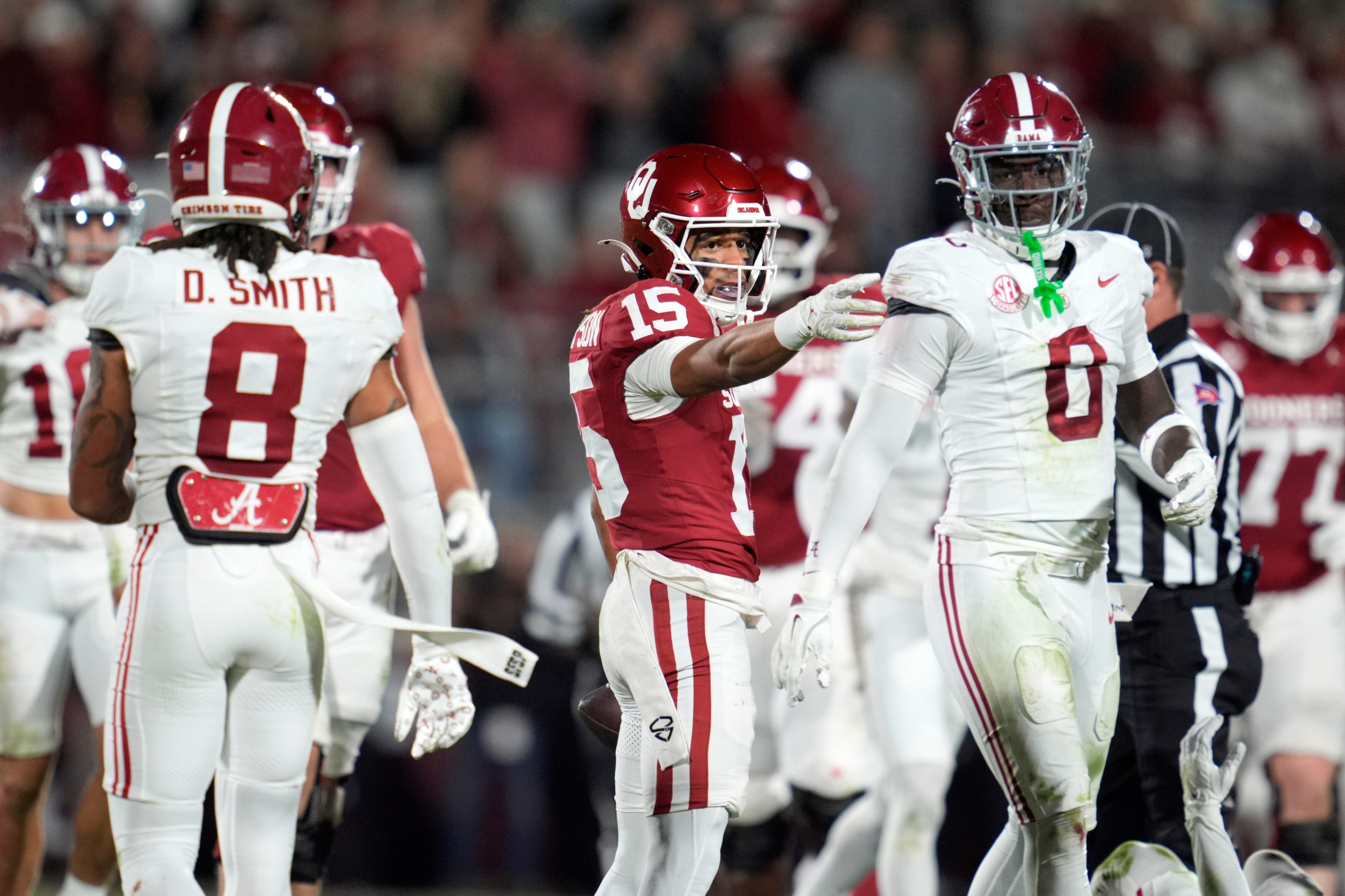 Oklahoma Sooners wide receiver Brenen Thompson (15) celebrates between Alabama Crimson Tide defensive back DeVonta Smith (8) and Alabama Crimson Tide linebacker Deontae Lawson (0) during a college football game between the University of Oklahoma Sooners (OU) and the Alabama Crimson Tide at Gaylord Family - Oklahoma Memorial Stadium in Norman, Okla., Saturday, Nov. 23, 2024. Oklahoma won 24-3.