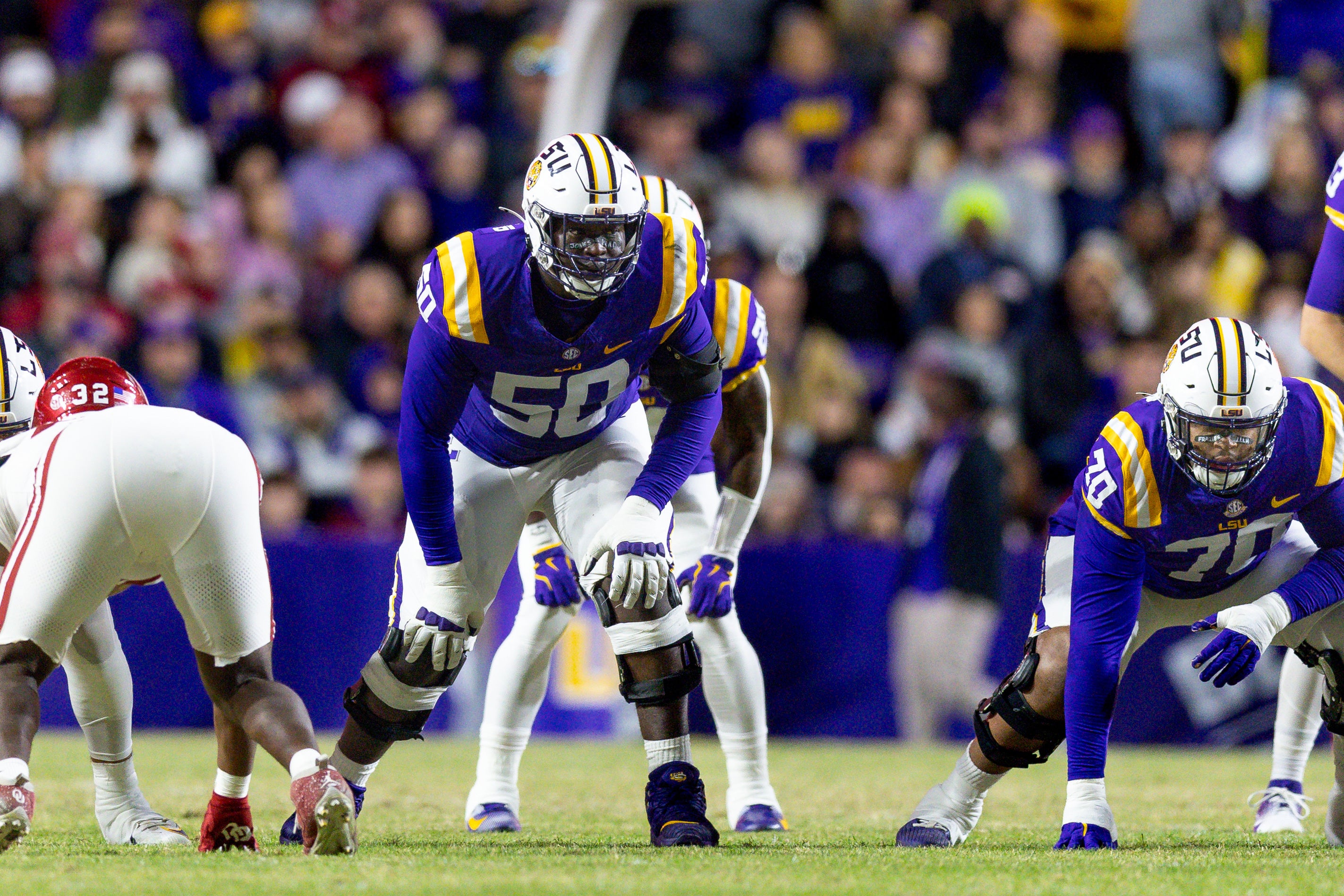Nov 30, 2024; Baton Rouge, Louisiana, USA; LSU Tigers offensive lineman Emery Jones Jr. (50) defends the line against Oklahoma Sooners defensive lineman R Mason Thomas (32) during the first quarter at Tiger Stadium.