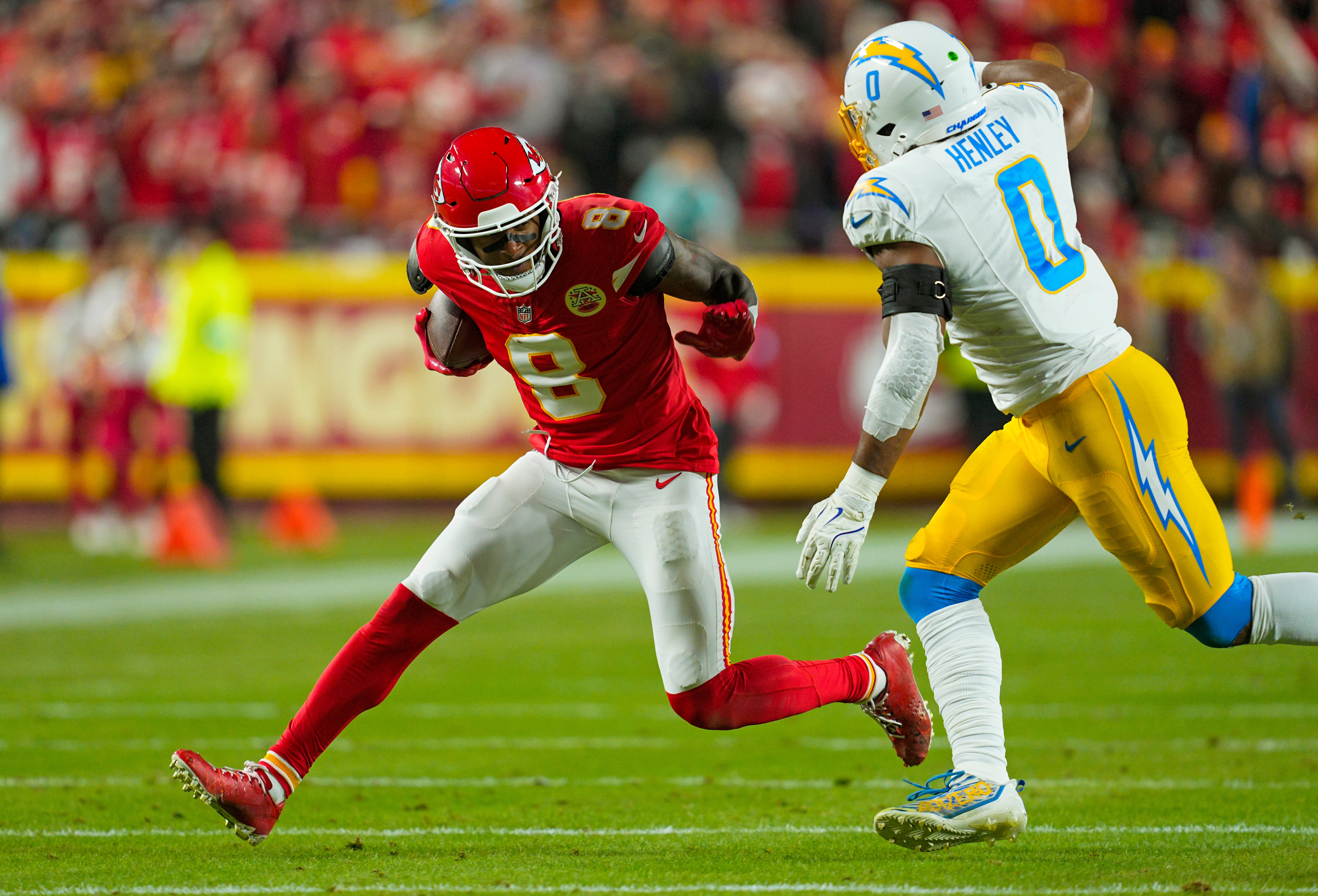 Dec 8, 2024; Kansas City, Missouri, USA; Kansas City Chiefs wide receiver DeAndre Hopkins (8) runs with the ball against Los Angeles Chargers linebacker Daiyan Henley (0) during the first half at GEHA Field at Arrowhead Stadium.