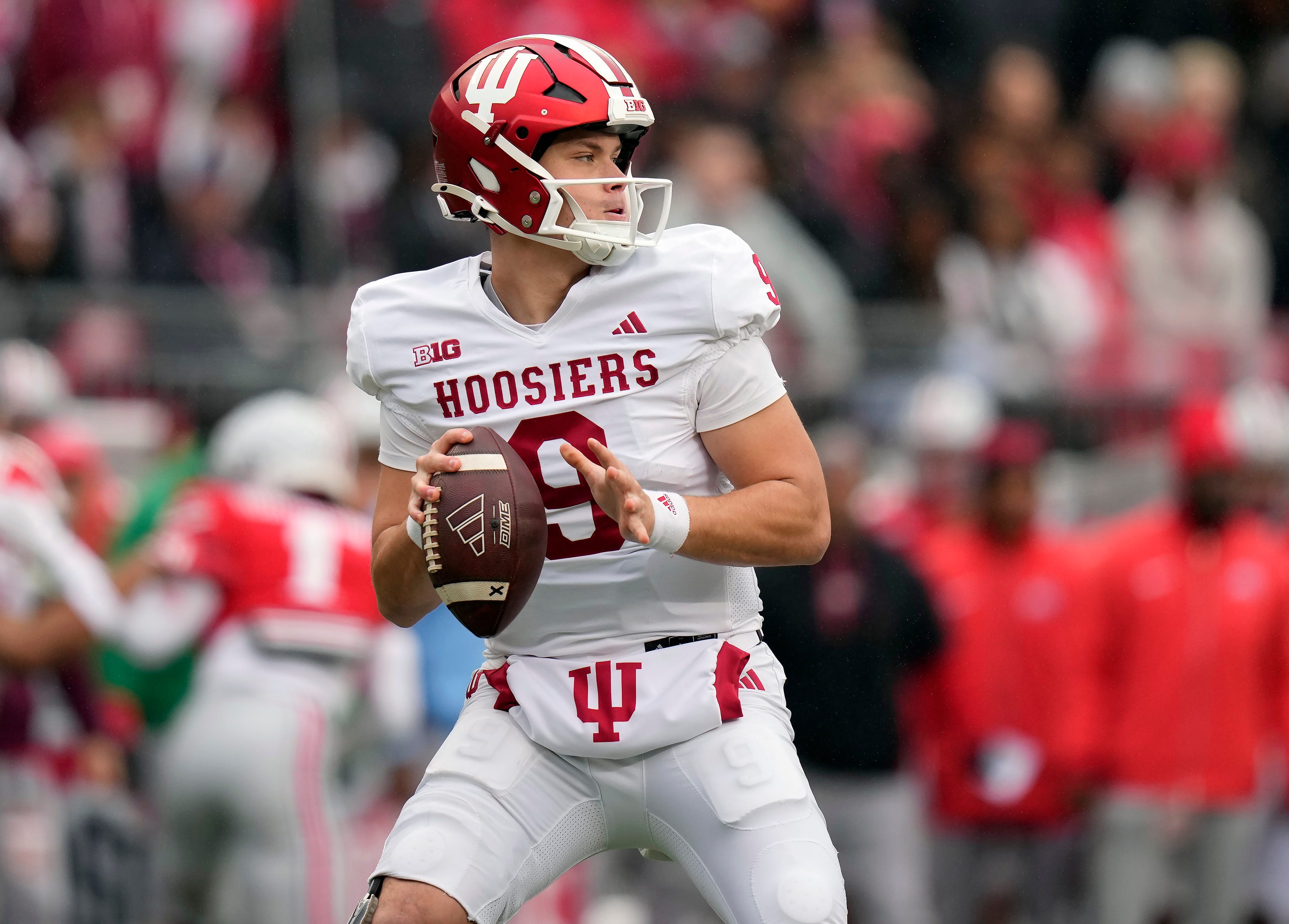 Indiana Hoosiers quarterback Kurtis Rourke (9) drops back to pass against Ohio State Buckeyes defense during the second quarter of the football game in Columbus on Saturday, Nov. 23, 2024.