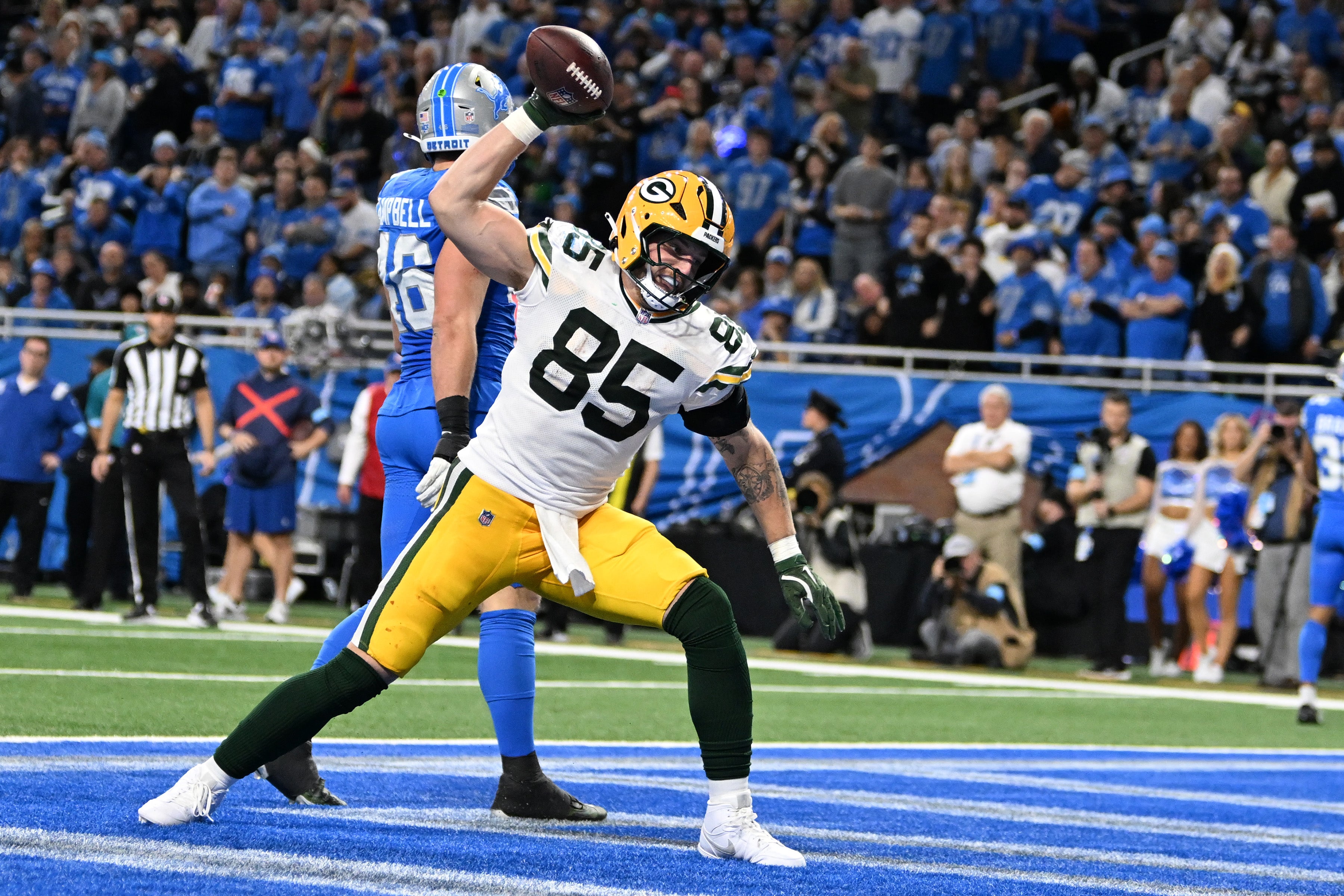 Packers tight end Tucker Kraft (85) spikes the ball after catching a touchdown pass against the Lions.