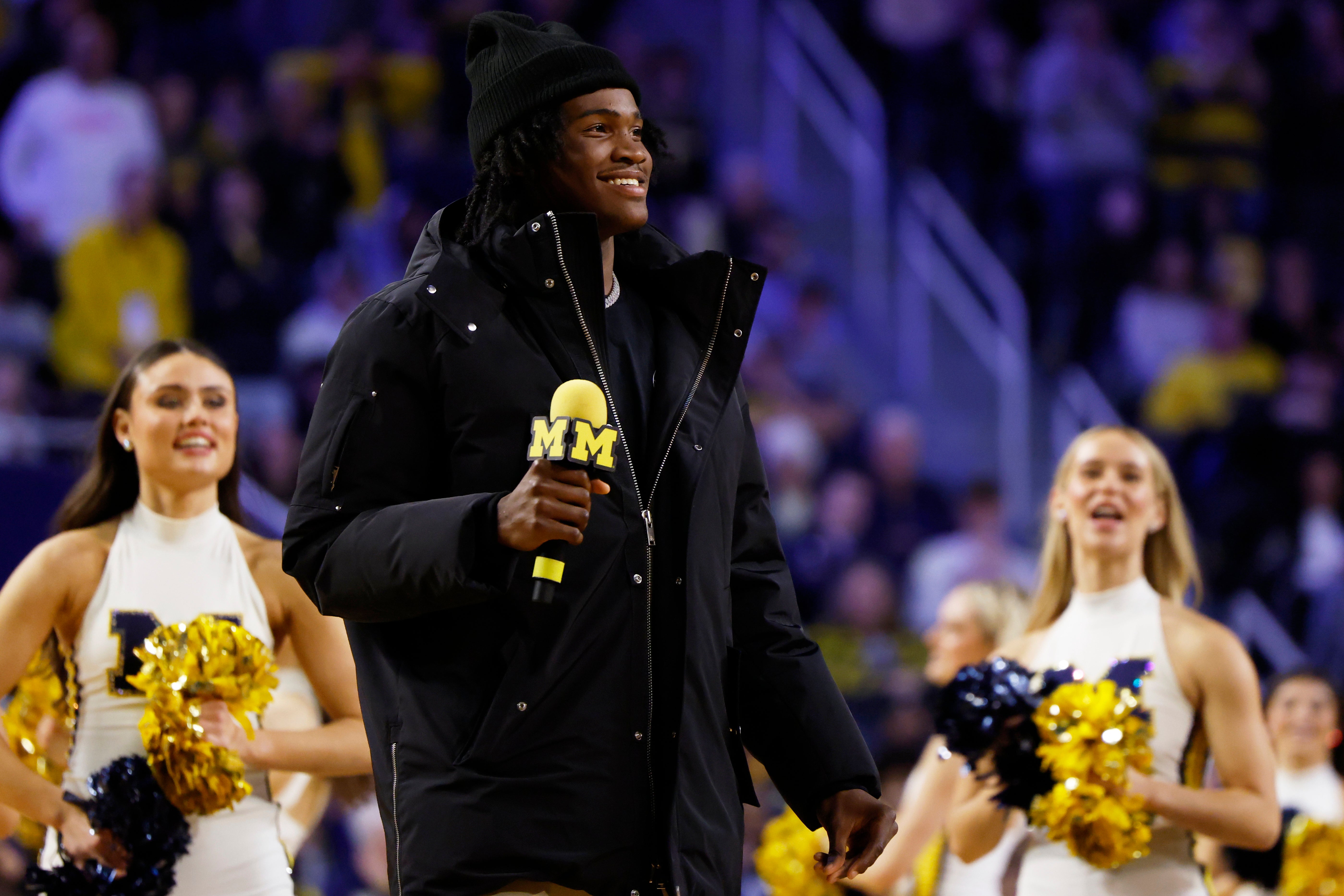 Michigan Wolverines quarterback commit Bryce Underwood addresses the crowd during a basketball game against the Iowa Hawkeyes at Crisler Center.