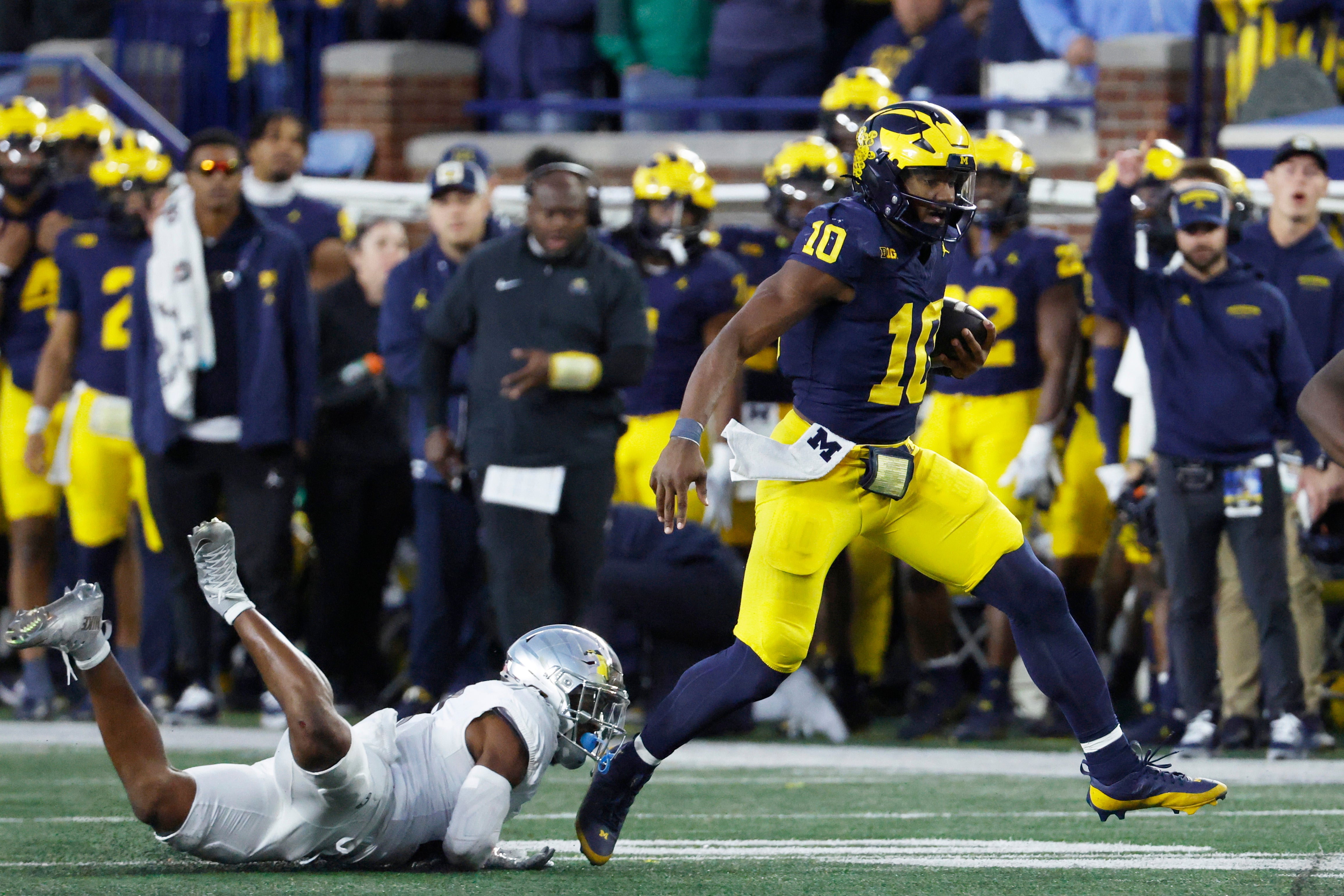 Nov 2, 2024; Ann Arbor, Michigan, USA; Michigan Wolverines quarterback Alex Orji (10) rushes in the second half against the Oregon Ducks at Michigan Stadium.
