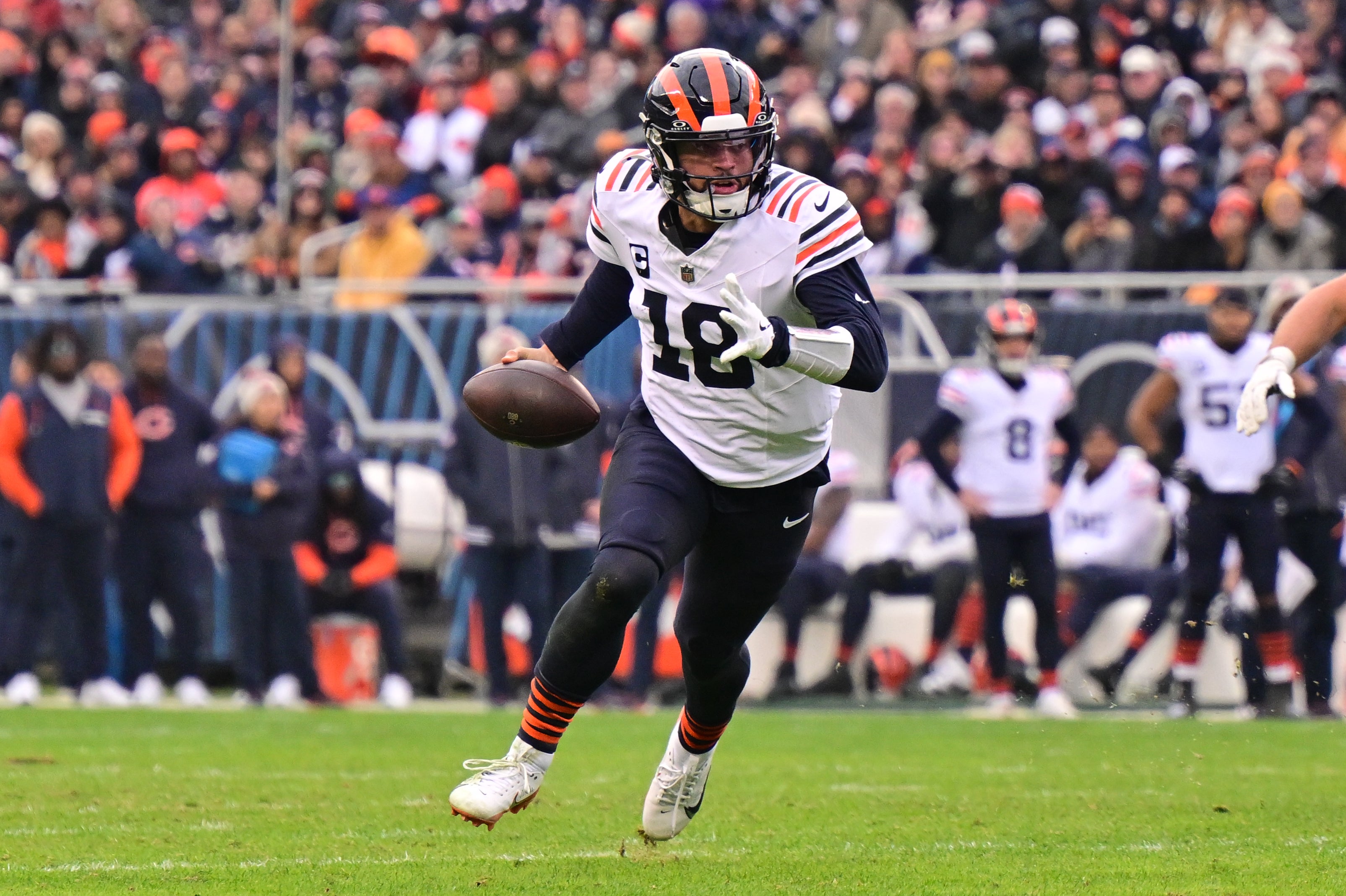 Nov 24, 2024; Chicago, Illinois, USA; Chicago Bears quarterback Caleb Williams (18) runs the ball against the Minnesota Vikings during the fourth quarter at Soldier Field.