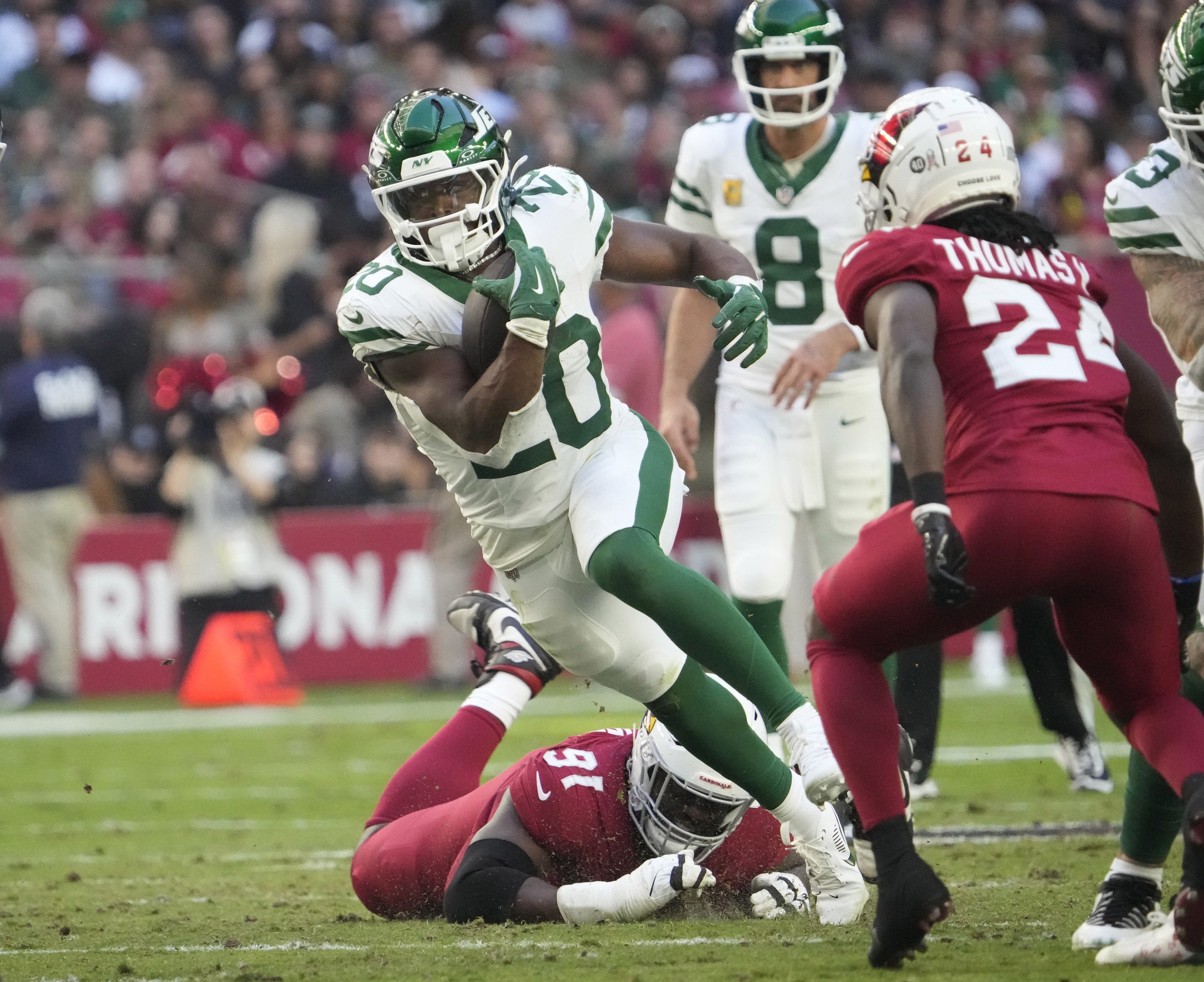 New York Jets running back Breece Hall (20) runs against Arizona Cardinals cornerback Starling Thomas V (24) during the second quarter at State Farm Stadium in Glendale on Nov. 10, 2024.
