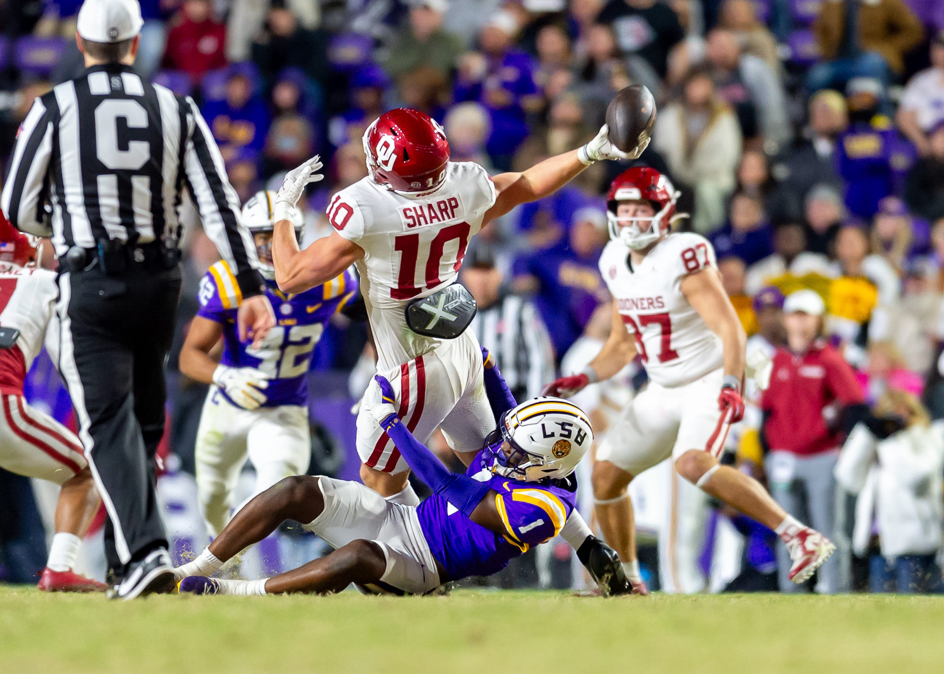 Ashton Stamps 1 tackles Sooners Bauer Sharp 10 causing an interception as the LSU Tigers take on the Oklahoma Sooners. Nov 30, 2024; Baton Rouge, Louisiana, USA; at Tiger Stadium.