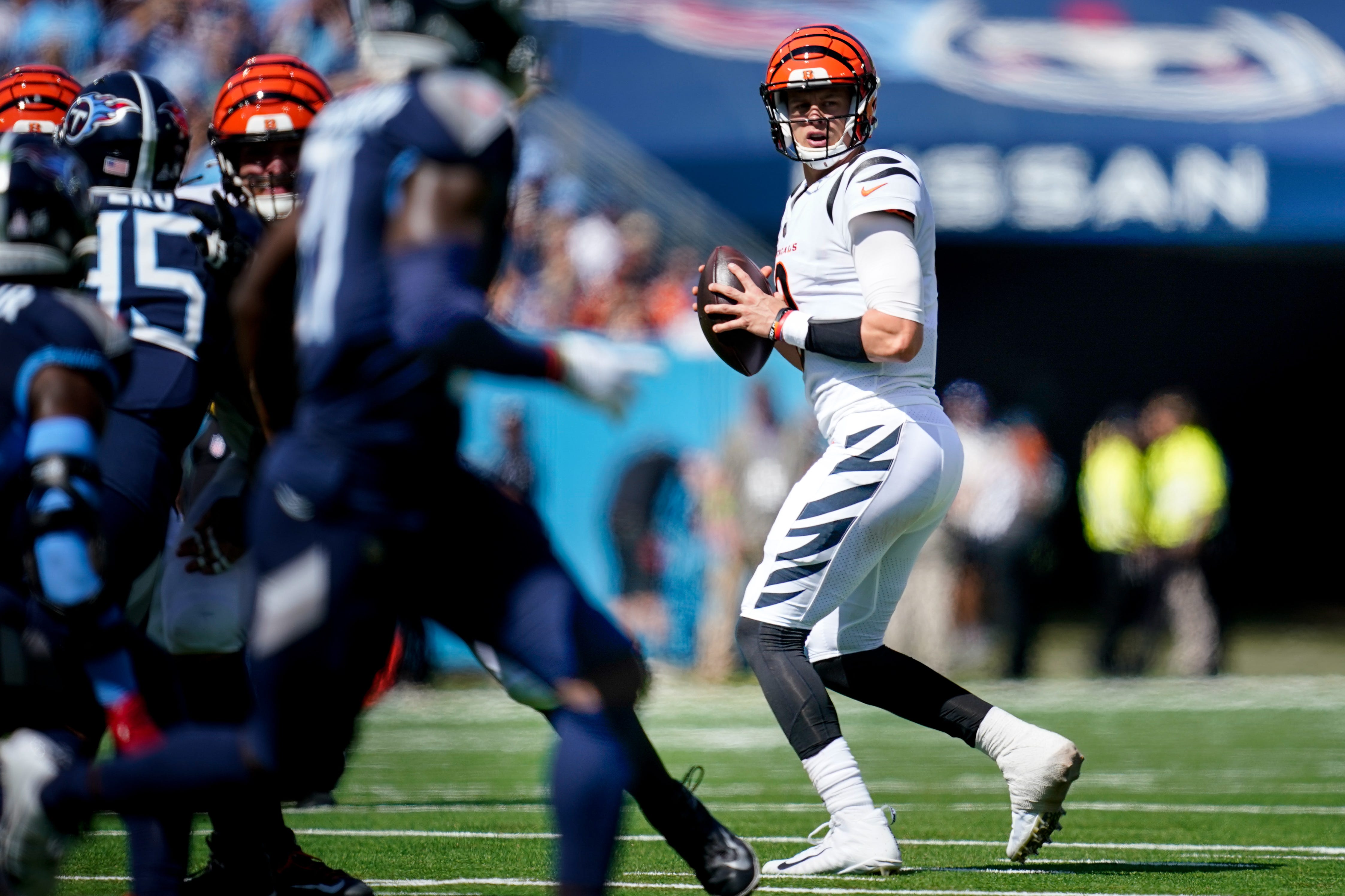 Cincinnati Bengals quarterback Joe Burrow (9) looks for an opening against the Tennessee Titans during the first quarter at Nissan Stadium in Nashville, Tenn., Sunday, Oct. 1, 2023.