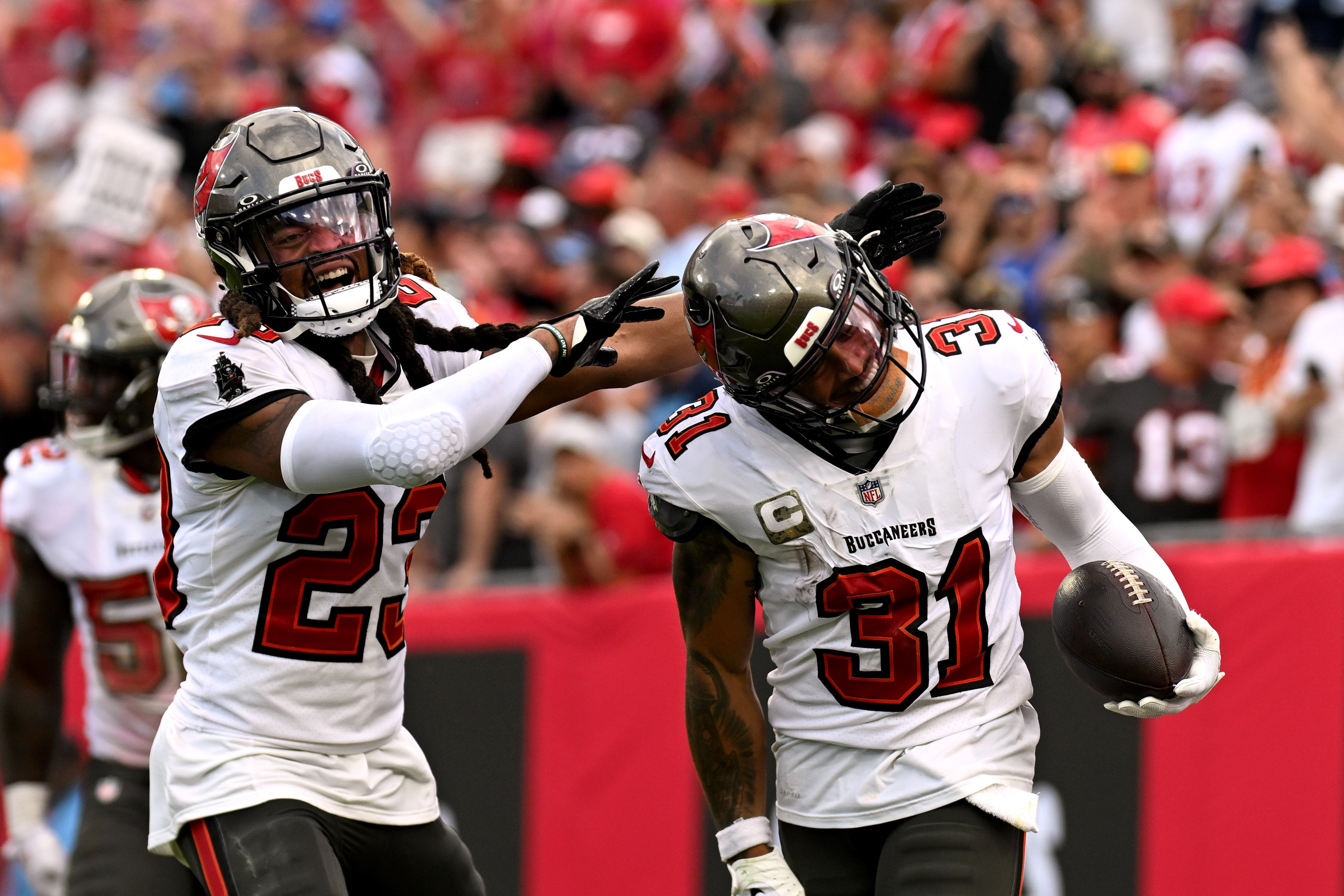 Nov 12, 2023; Tampa, Florida, USA; Tampa Bay Buccaneers defensive back Antoine Winfield Jr. (31) celebrates with defensive back Ryan Neal (23) after an interception in the second half against the Tennessee Titans Raymond James Stadium.