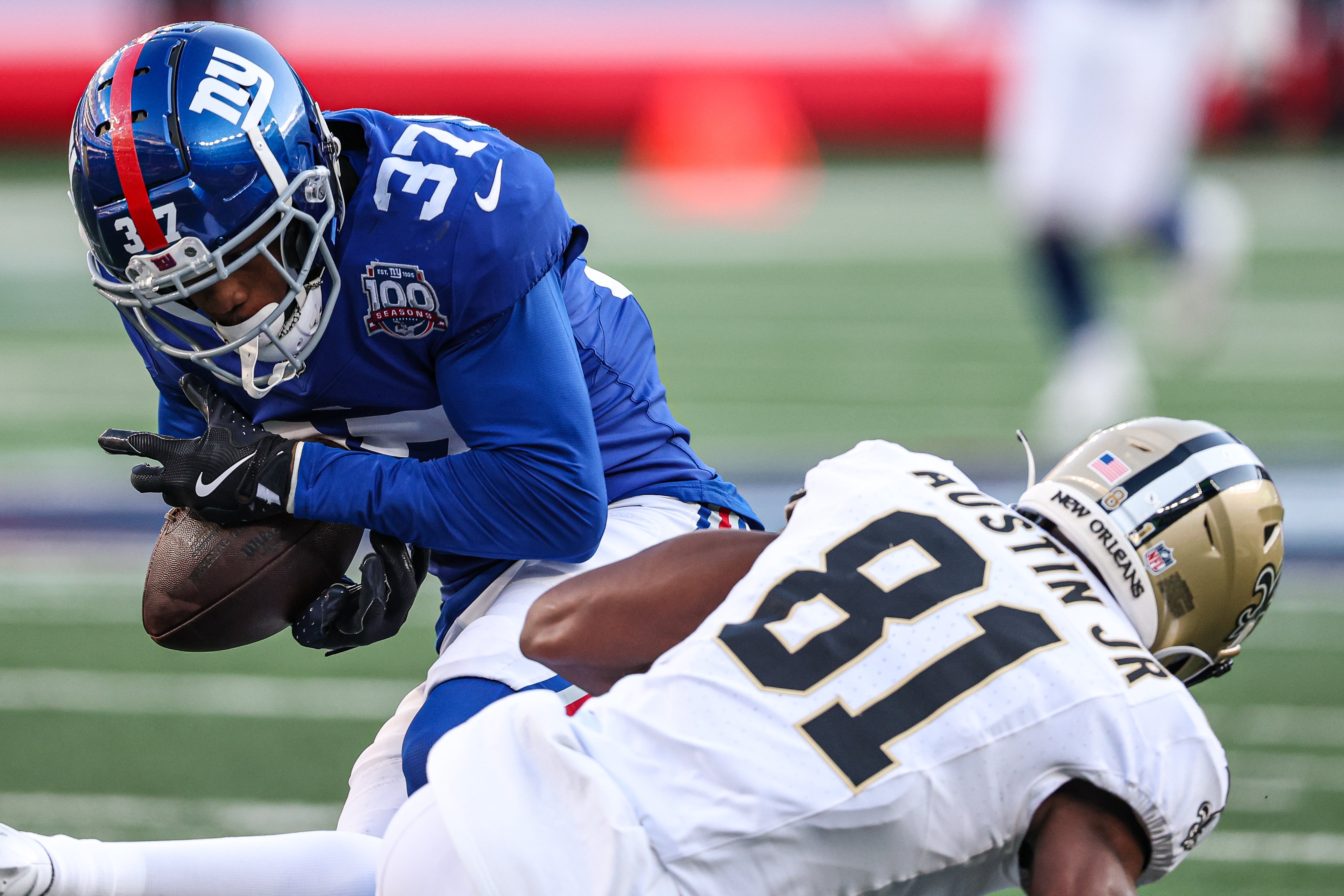 New York Giants cornerback Tre Hawkins III (37) intercepts a pass intended for New Orleans Saints wide receiver Kevin Austin Jr. (81) during the second half at MetLife Stadium.