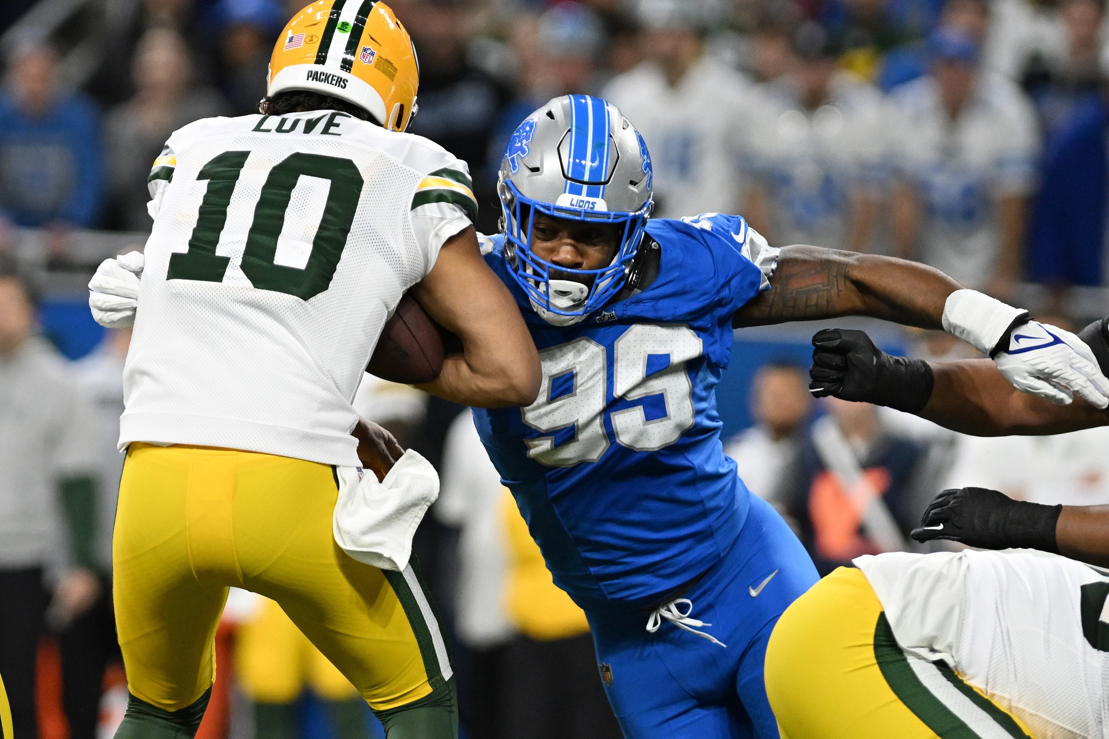 Green Bay Packers quarterback Jordan Love (10) is sacked by Detroit Lions defensive end Za'Darius Smith (99), during the Thursday Night Football at Ford Field in Detroit on Thursday, Dec. 5, 2024.