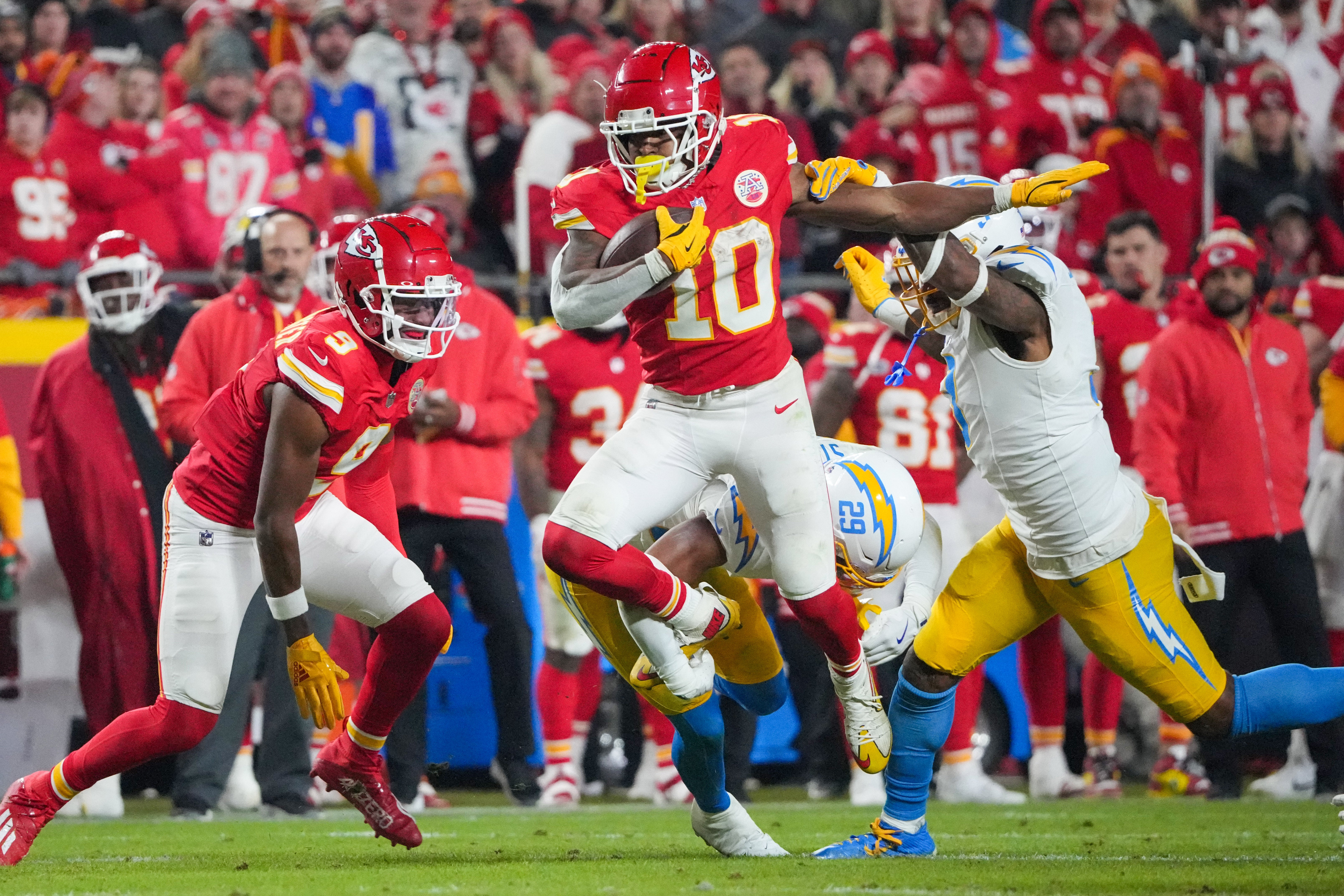 Chiefs running back Isiah Pacheco (10) runs the ball as Chargers safety Derwin James Jr. (3) attempts the tackle.