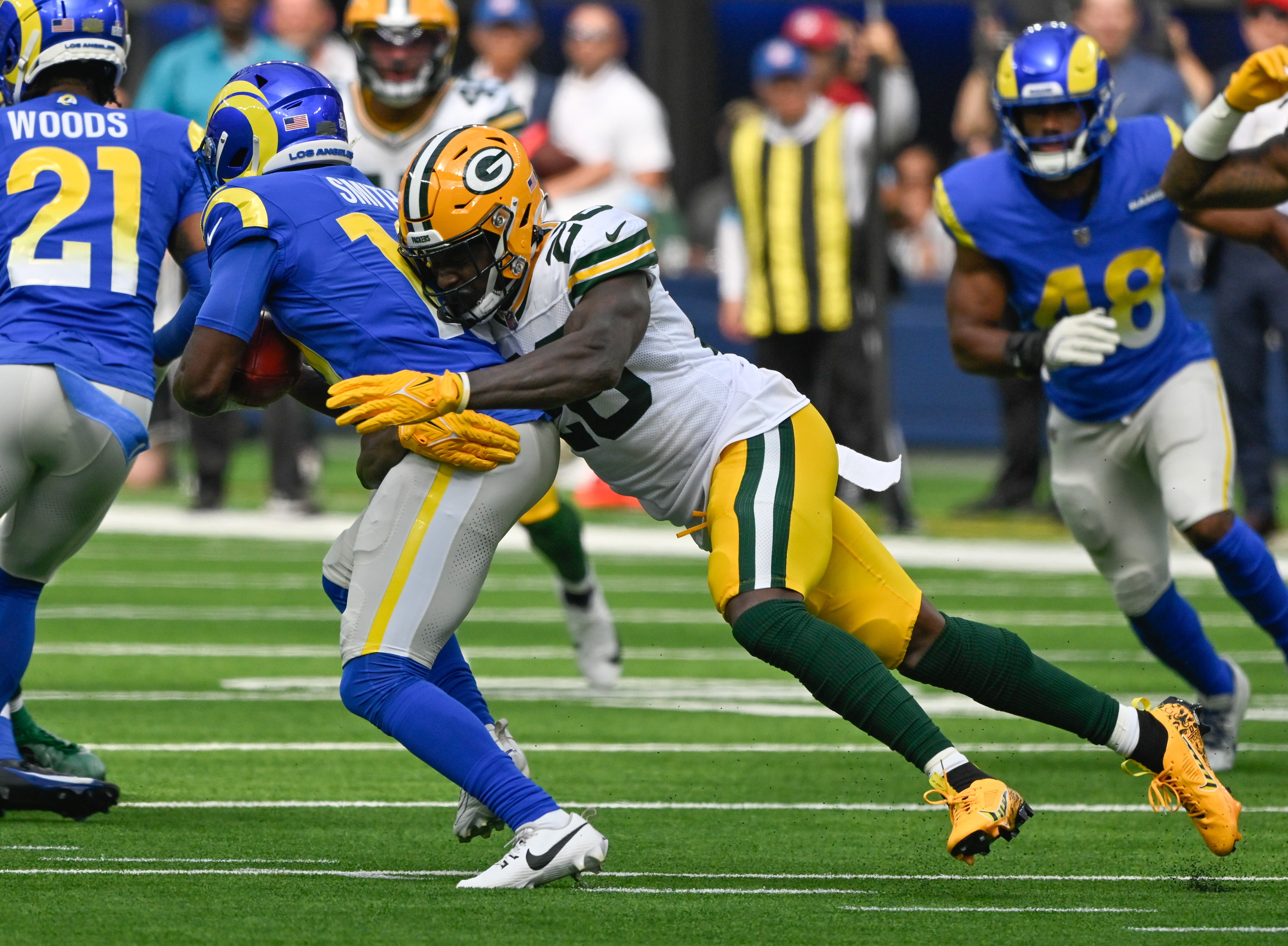 Green Bay Packers cornerback Corey Ballentine (26) tackles Los Angeles Rams wide receiver Xavier Smith (19) during the first quarter at SoFi Stadium.