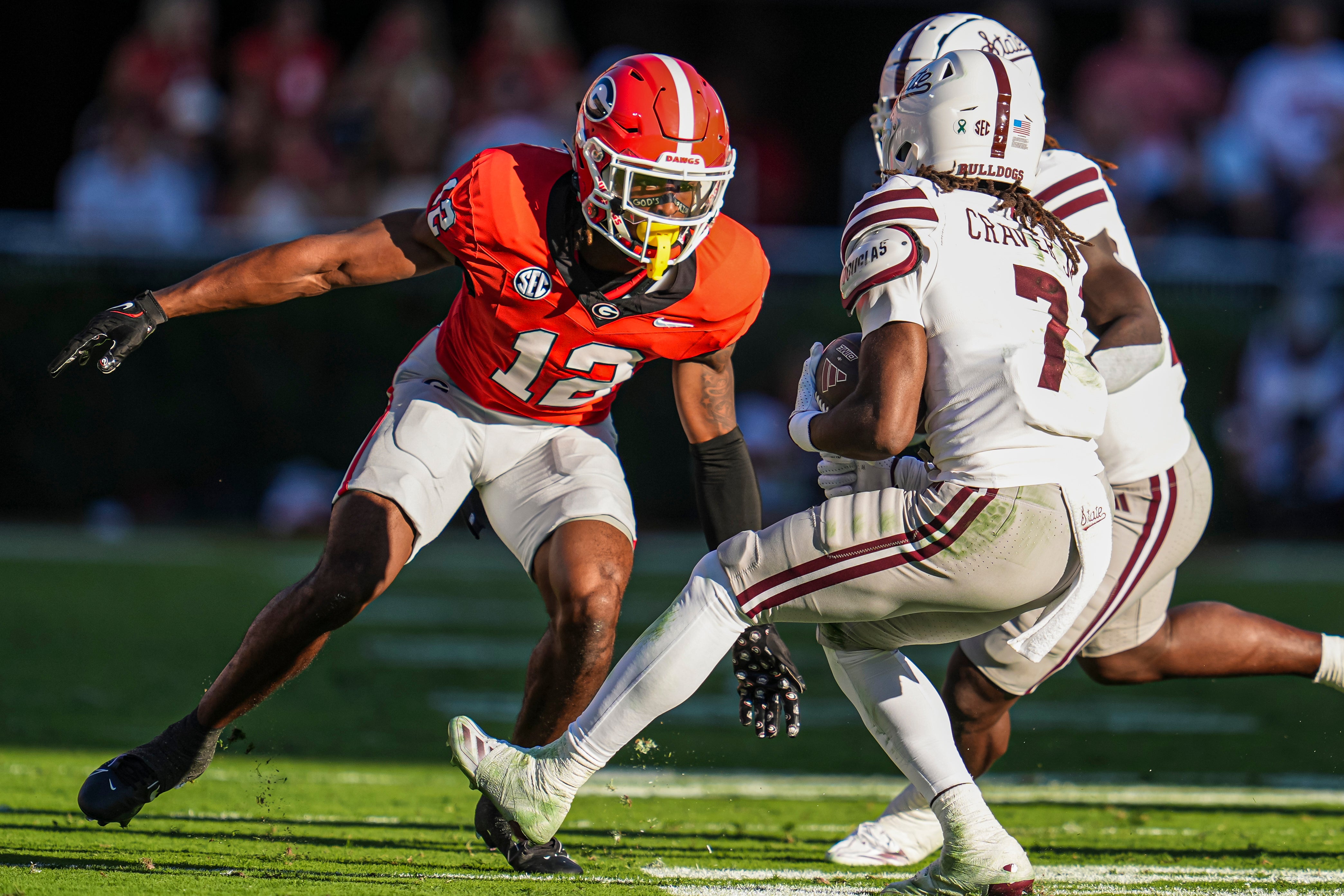 Georgia Bulldogs defensive back Julian Humphrey (12) tries got tackle Mississippi State Bulldogs wide receiver Mario Craver (7) at Sanford Stadium.