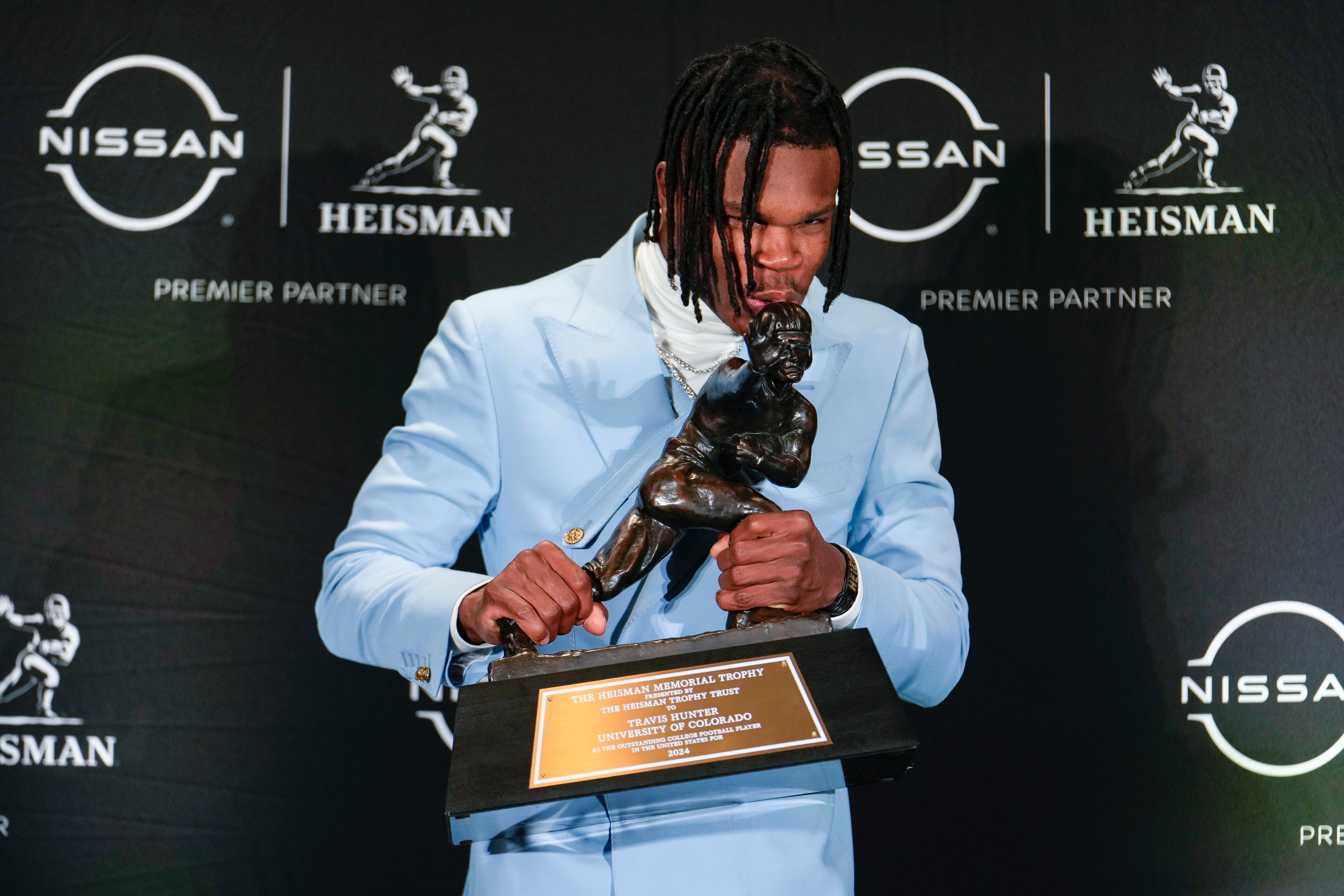 Colorado Buffaloes wide receiver/cornerback Travis Hunter poses for a photo after winning the Heisman Trophy award during the 2024 Heisman Trophy Presentation. Lucas Boland-Imagn Images