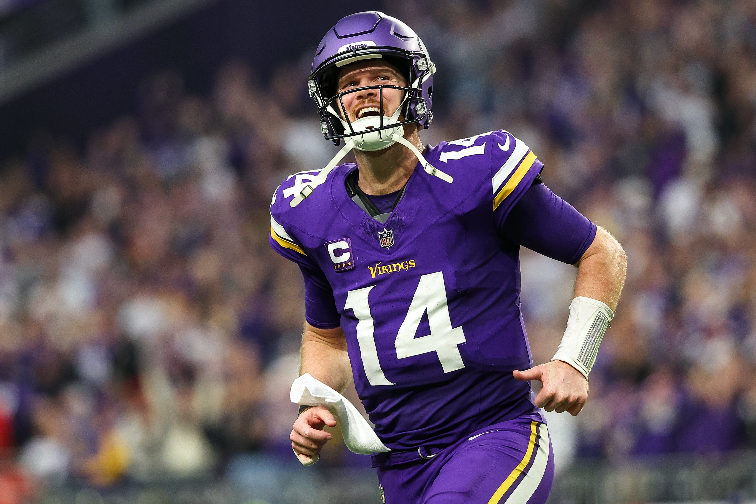 Dec 8, 2024; Minneapolis, Minnesota, USA; Minnesota Vikings quarterback Sam Darnold (14) celebrates running back Aaron Jones' (33) touchdown run against the Atlanta Falcons during the fourth quarter at U.S. Bank Stadium. Mandatory Credit: Matt Krohn-Imagn Images