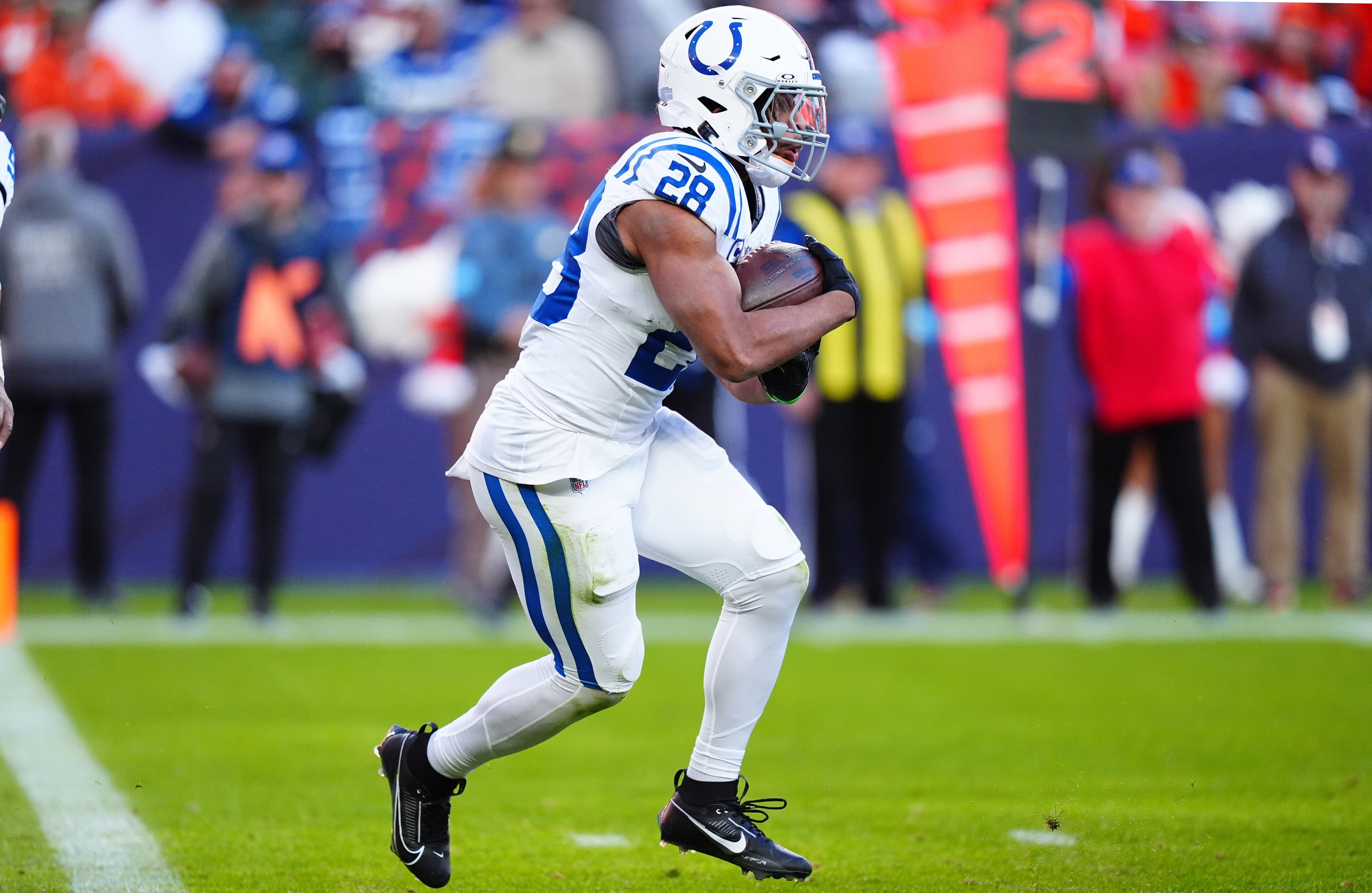 Dec 15, 2024; Denver, Colorado, USA; Indianapolis Colts running back Jonathan Taylor (28) carries the ball in the first half against the Denver Broncos at Empower Field at Mile High.