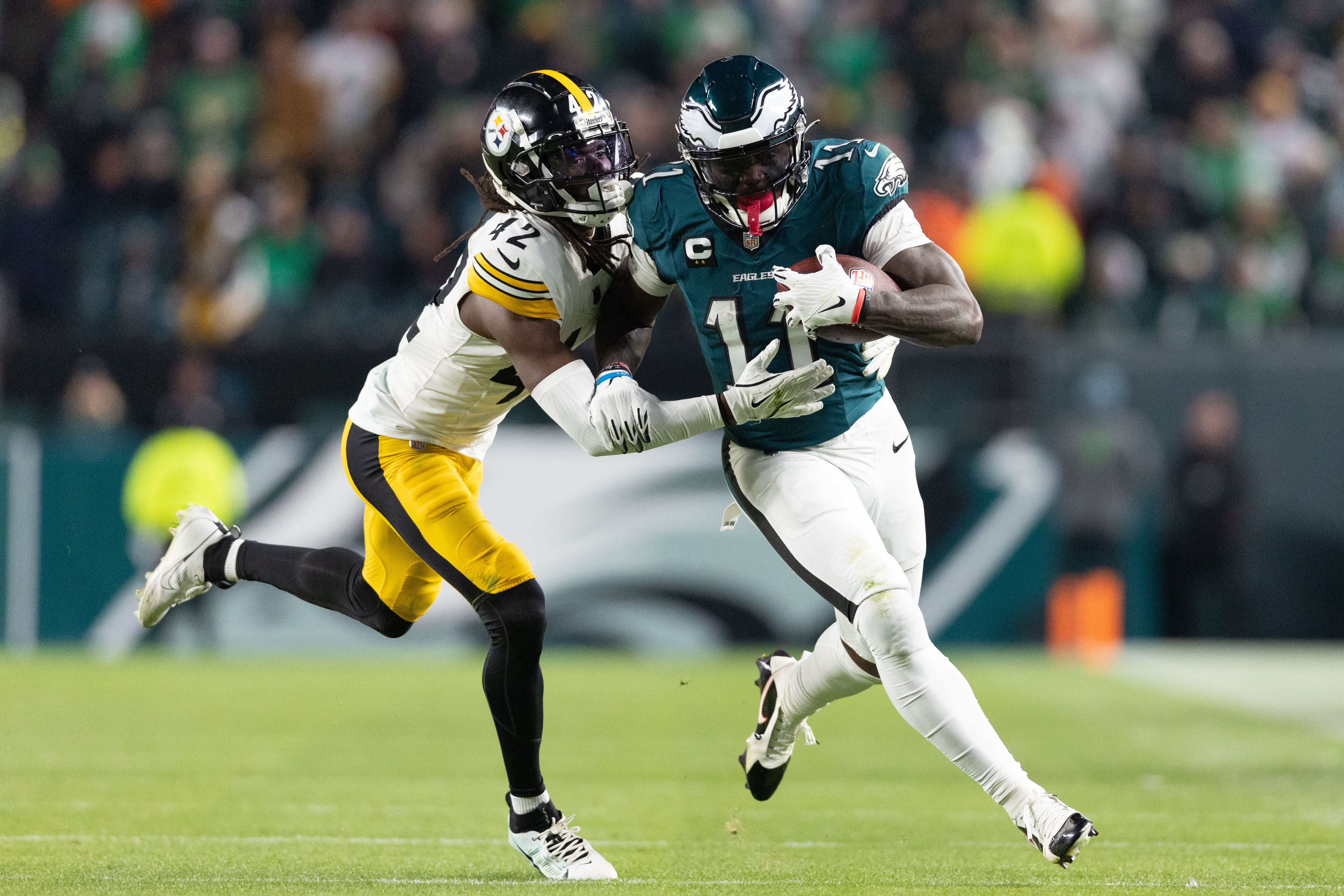 Dec 15, 2024; Philadelphia, Pennsylvania, USA; Philadelphia Eagles wide receiver A.J. Brown (11) runs with the ball against Pittsburgh Steelers cornerback James Pierre (42) after a catch during the fourth quarter at Lincoln Financial Field.