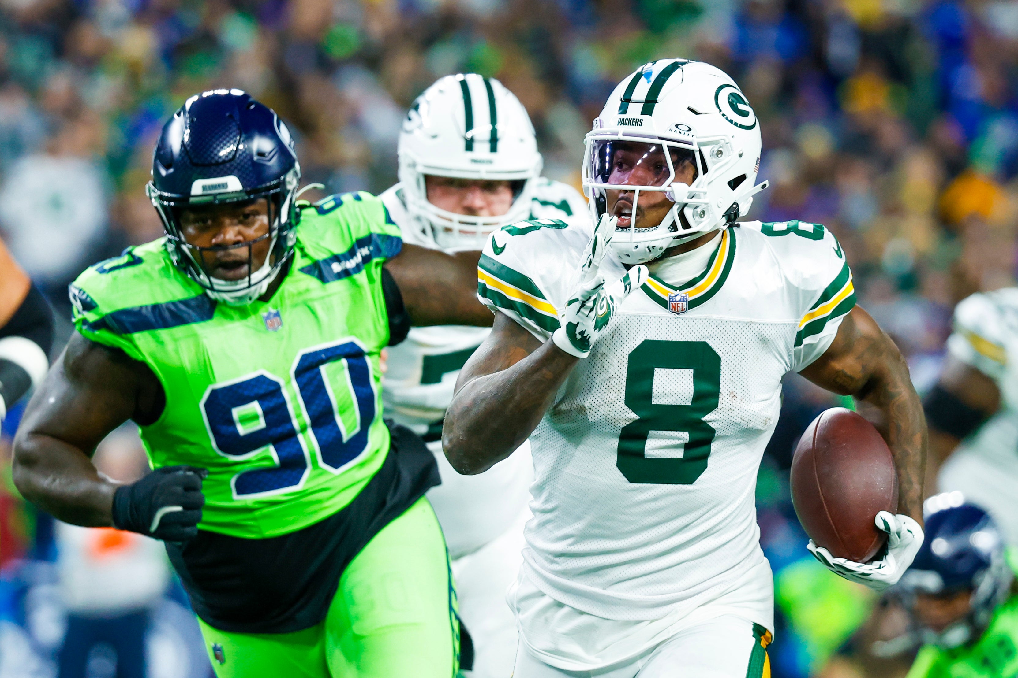 Green Bay Packers running back Josh Jacobs (8) rushes against the Seattle Seahawks during the first quarter at Lumen Field.
