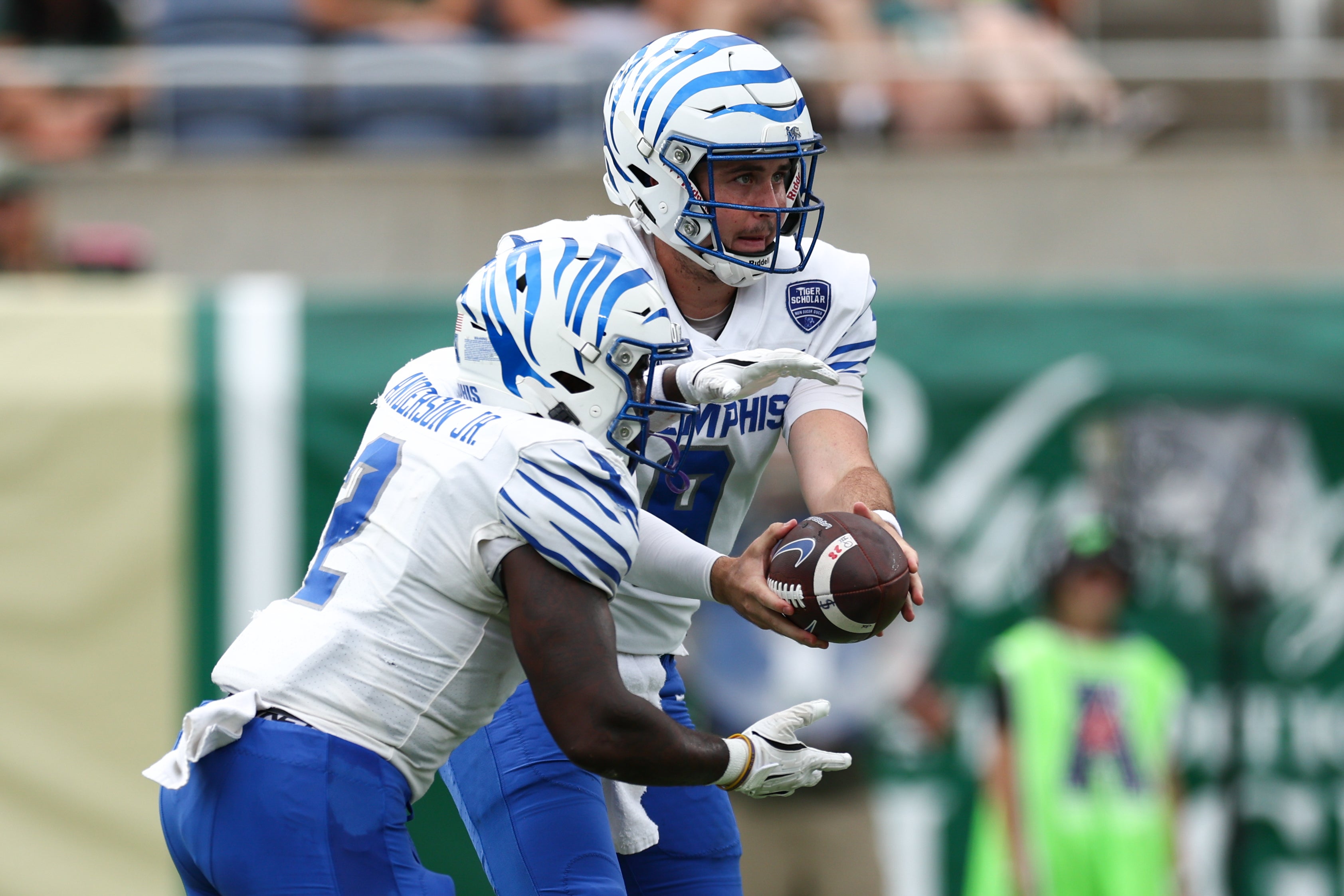 Oct 12, 2024; Orlando, Florida, USA; Memphis Tigers quarterback Seth Henigan (9) hands off to running back Mario Anderson Jr. (2) against the South Florida Bulls in the first quarter at Camping World Stadium.