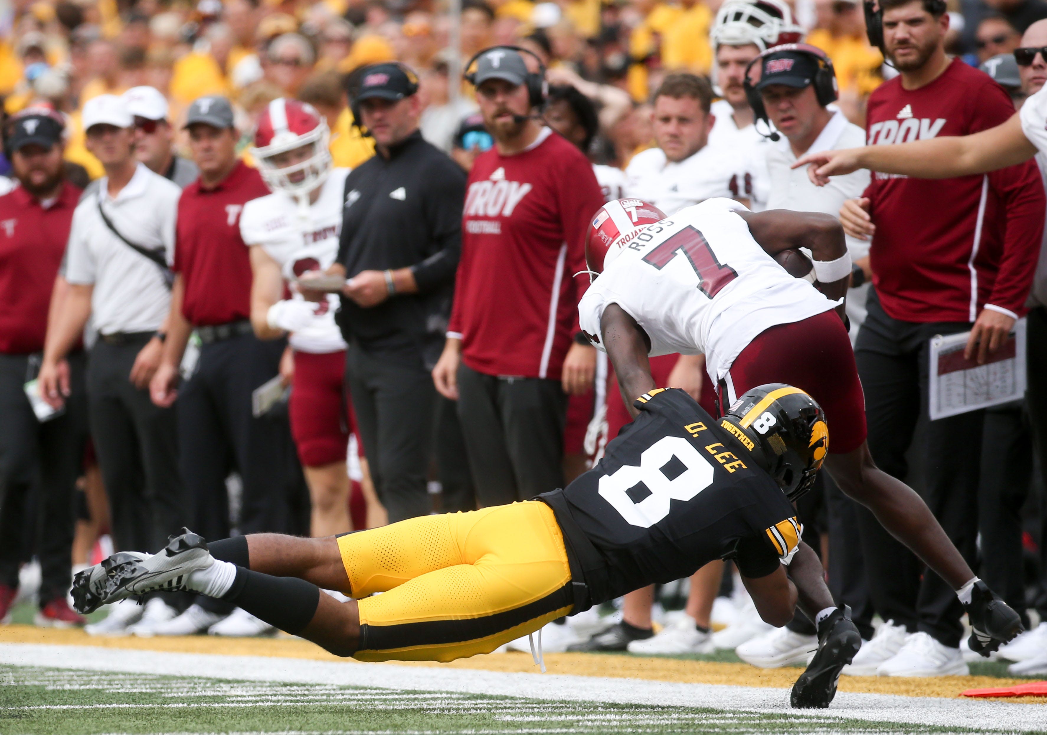 Iowa’s Deshaun Lee (8) tackles Troy’s wide receiver Devonte Ross (7) Saturday, Sept. 14, 2024 at Kinnick Stadium in Iowa City, Iowa.