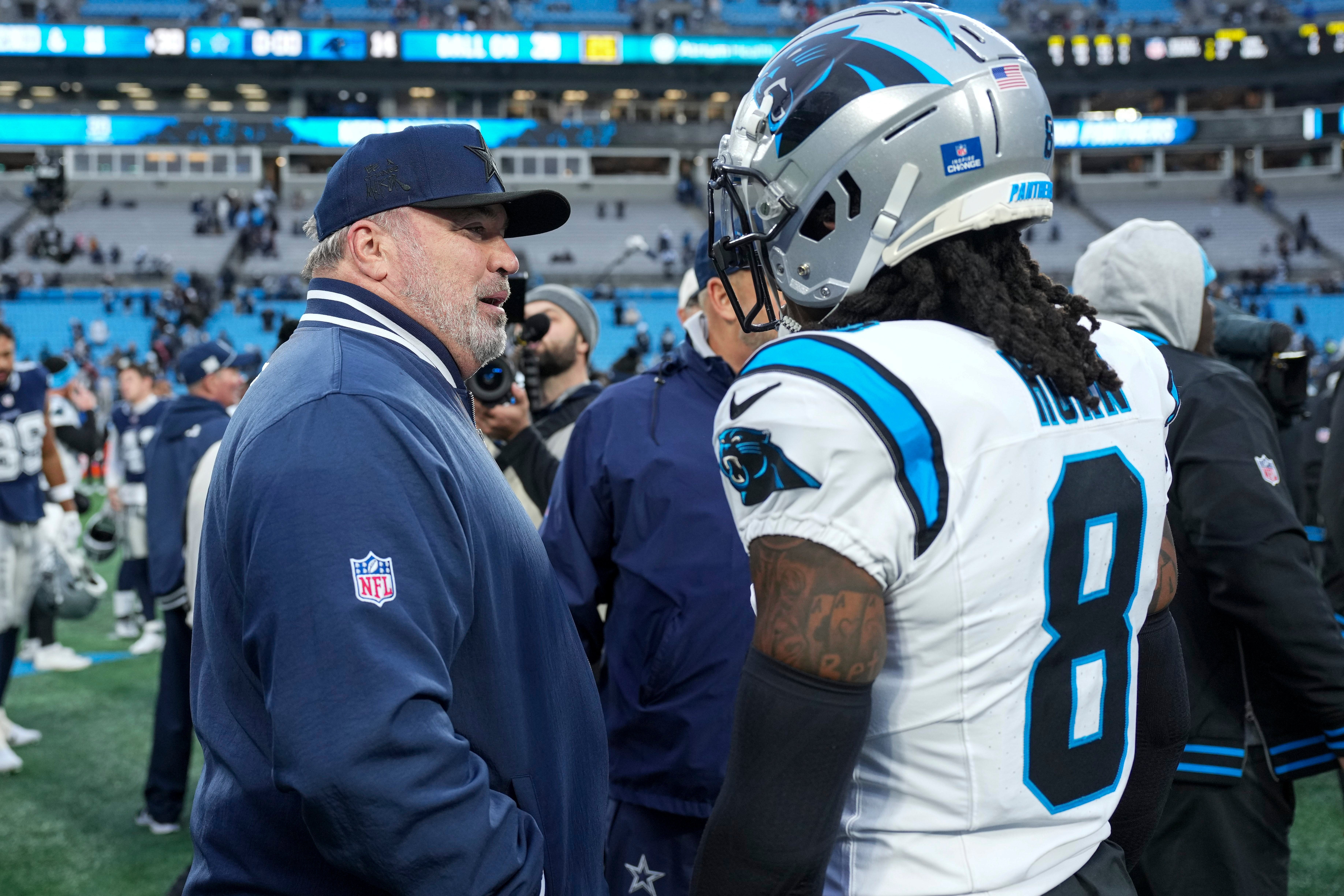 Dallas Cowboys head coach Mike McCarthy talks with Carolina Panthers cornerback Jaycee Horn (8) after a game at Bank of America Stadium.
