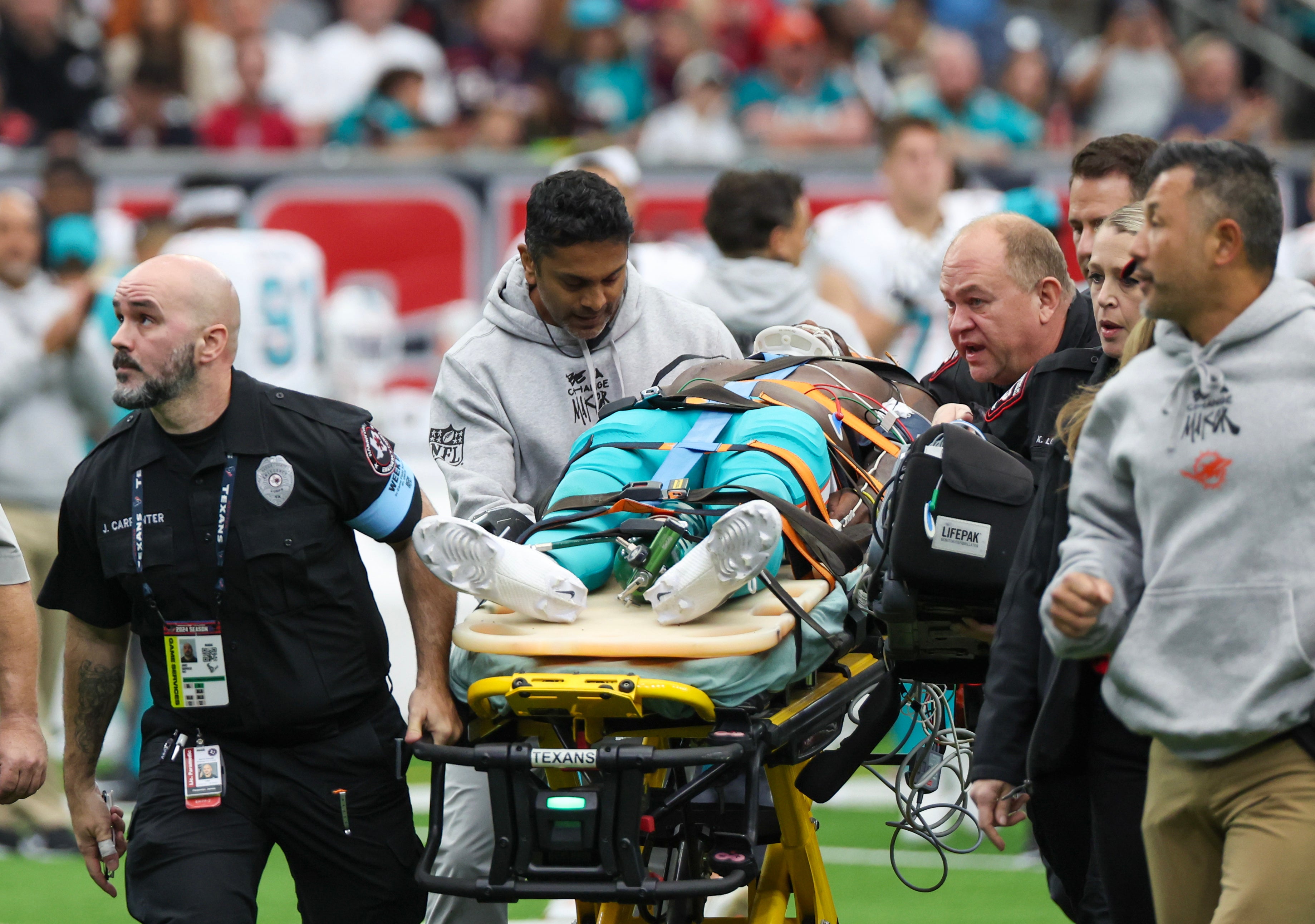 Dec 15, 2024; Houston, Texas, USA; Miami Dolphins wide receiver Grant DuBose (88) is taken off the filed by the medical team after he was injured during the third quarter against the Houston Texans at NRG Stadium.
