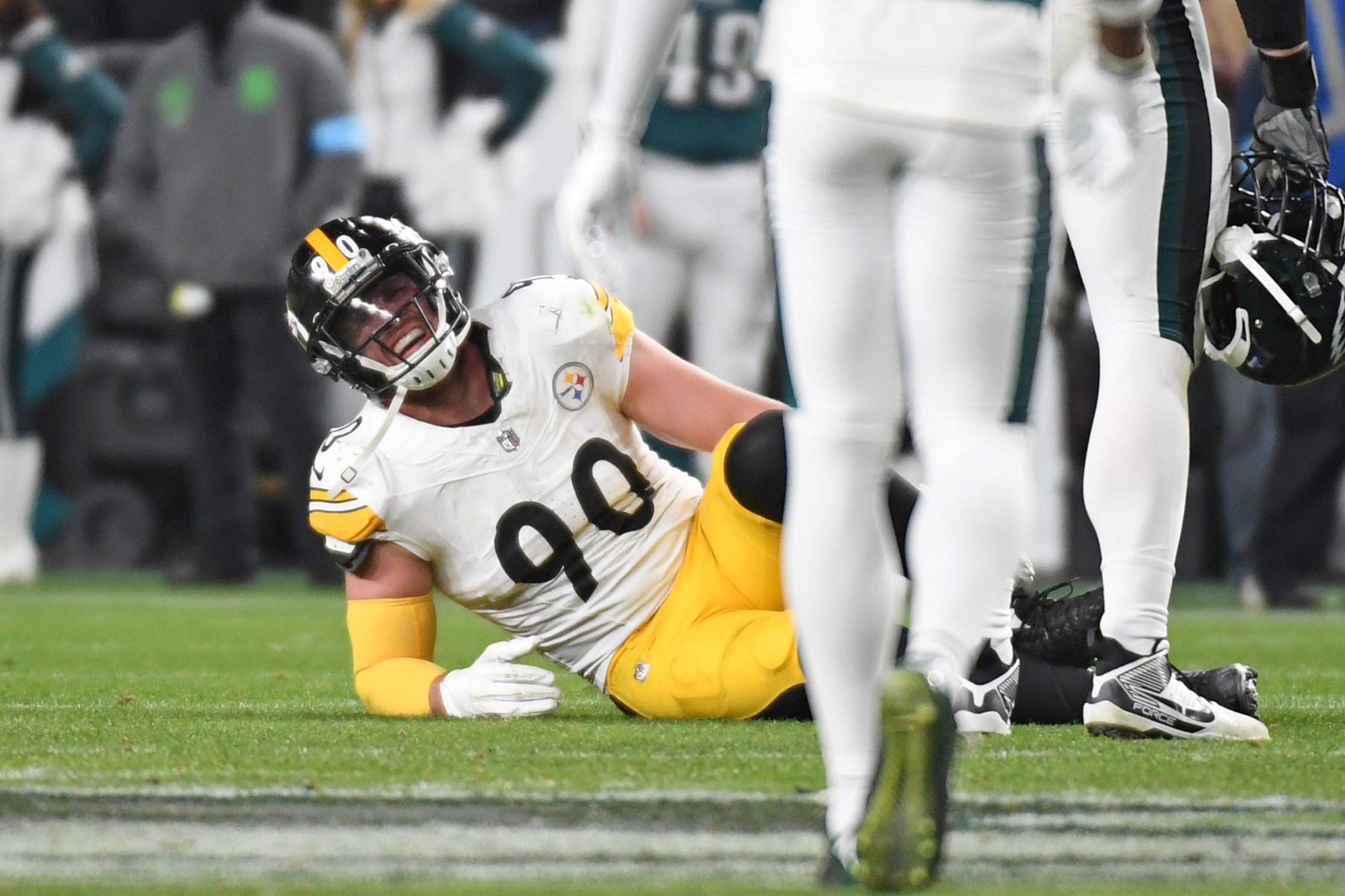Dec 15, 2024; Philadelphia, Pennsylvania, USA; Pittsburgh Steelers linebacker T.J. Watt (90) grimaces in pain as during the fourth quarter against the Philadelphia Eagles at Lincoln Financial Field.