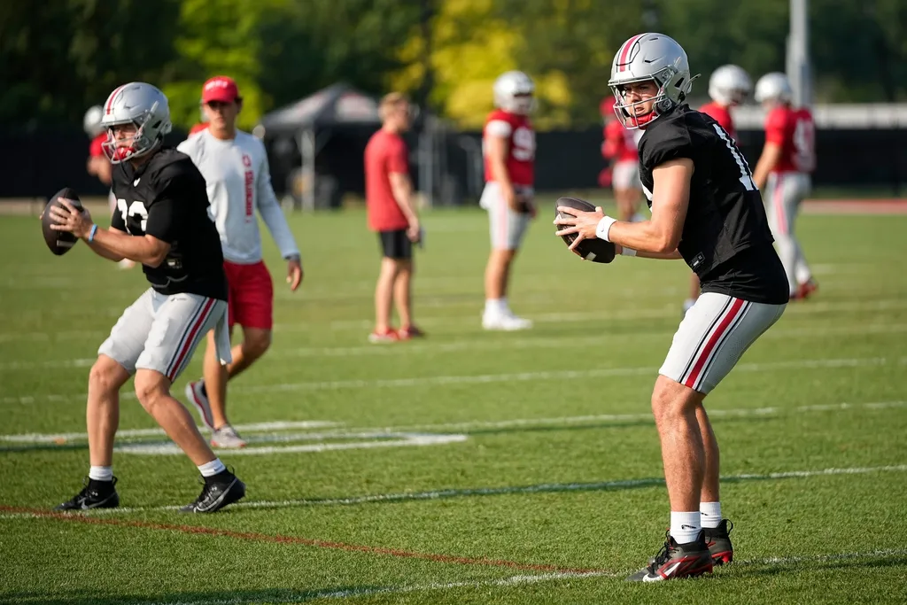 Ohio State Buckeyes quarterbacks Will Howard (18) and Devin Brown (33) take snaps during football practice at the Woody Hayes Athletic Complex