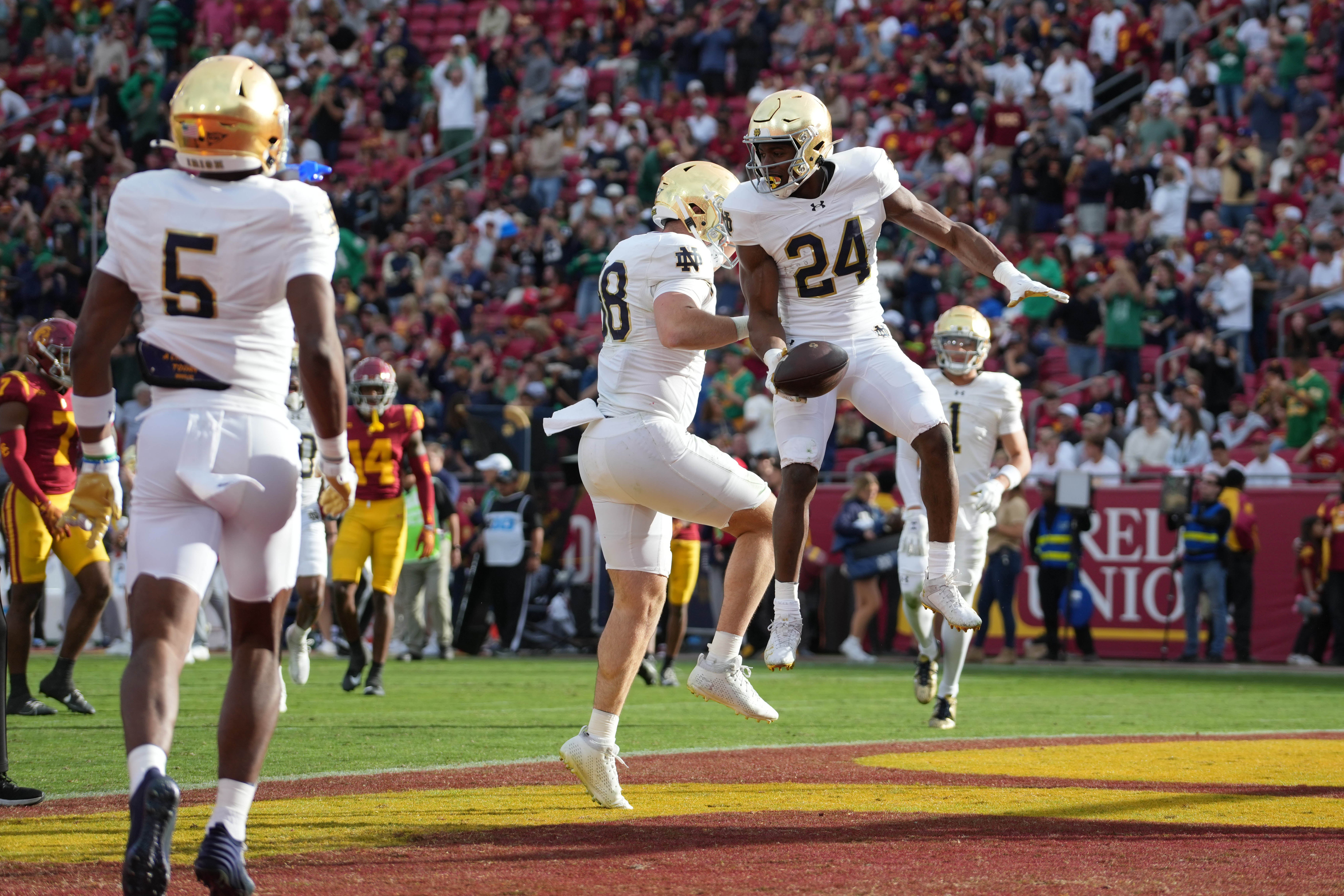 Notre Dame Fighting Irish running back Jadarian Price (24) celebrates with tight end Mitchell Evans (88) after scoring on a 36-yard touchdown run.