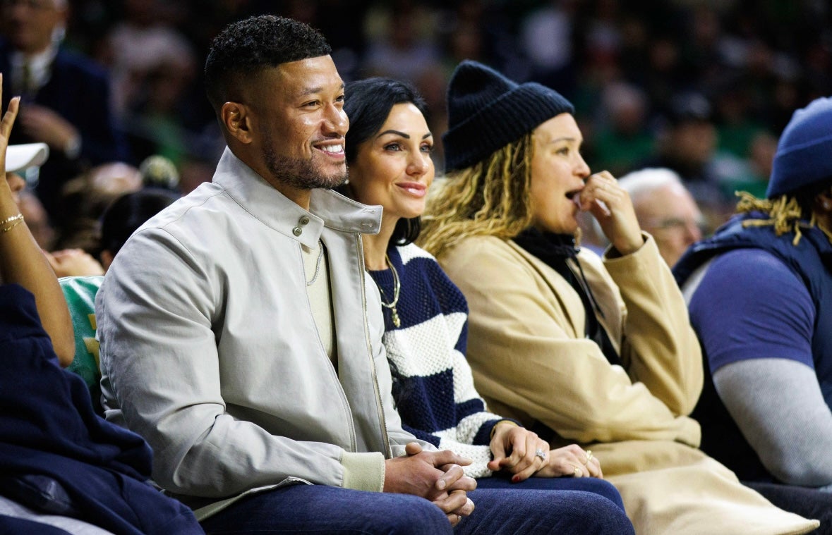 Notre Dame football head coach Marcus Freeman sits on the sidelines and watches a NCAA women's basketball game between Notre Dame and Texas at Purcell Pavilion on Thursday, Dec. 5, 2024, in South Bend.