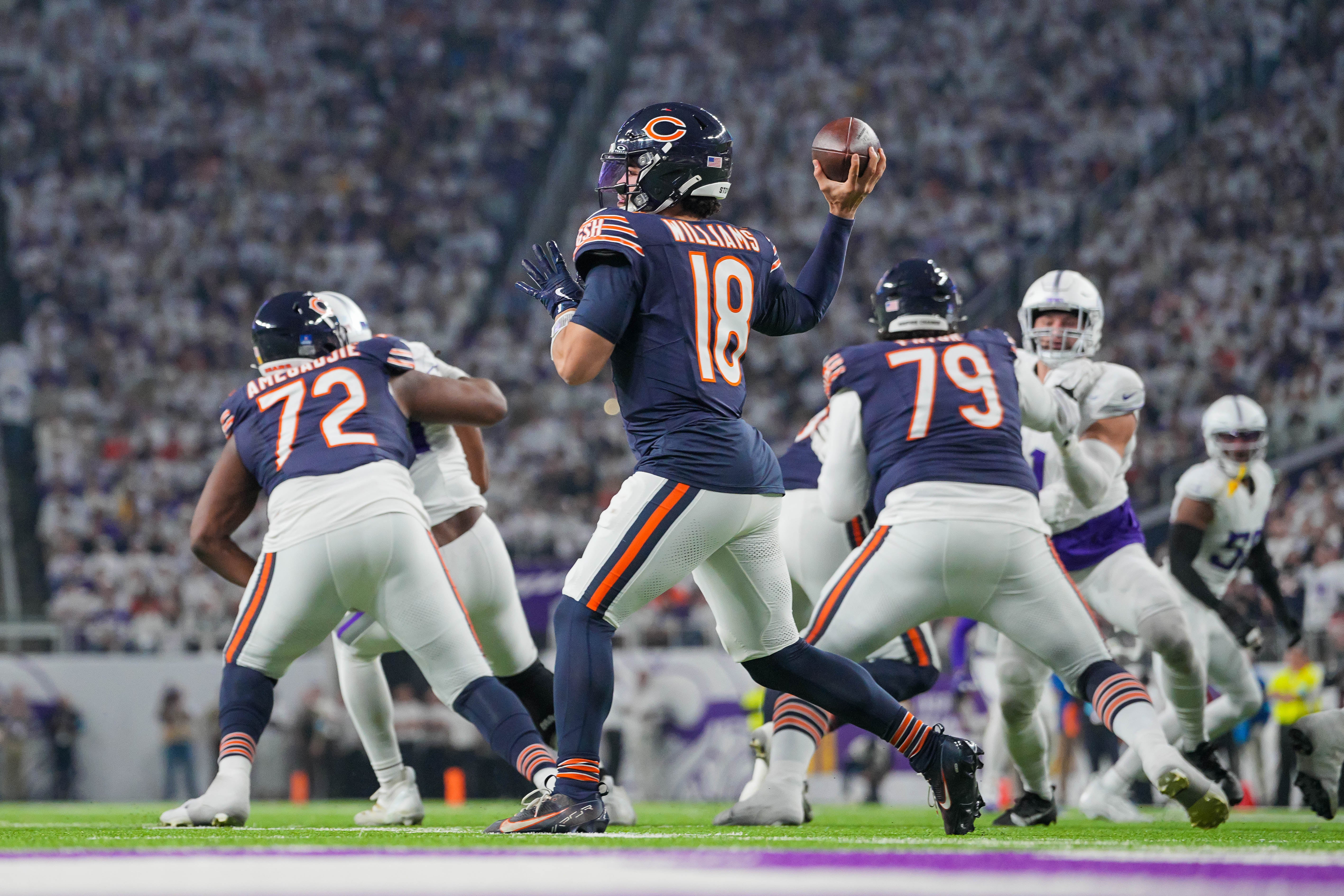 Dec 16, 2024; Minneapolis, Minnesota, USA; Chicago Bears quarterback Caleb Williams (18) passes against the Minnesota Vikings in the second quarter at U.S. Bank Stadium.