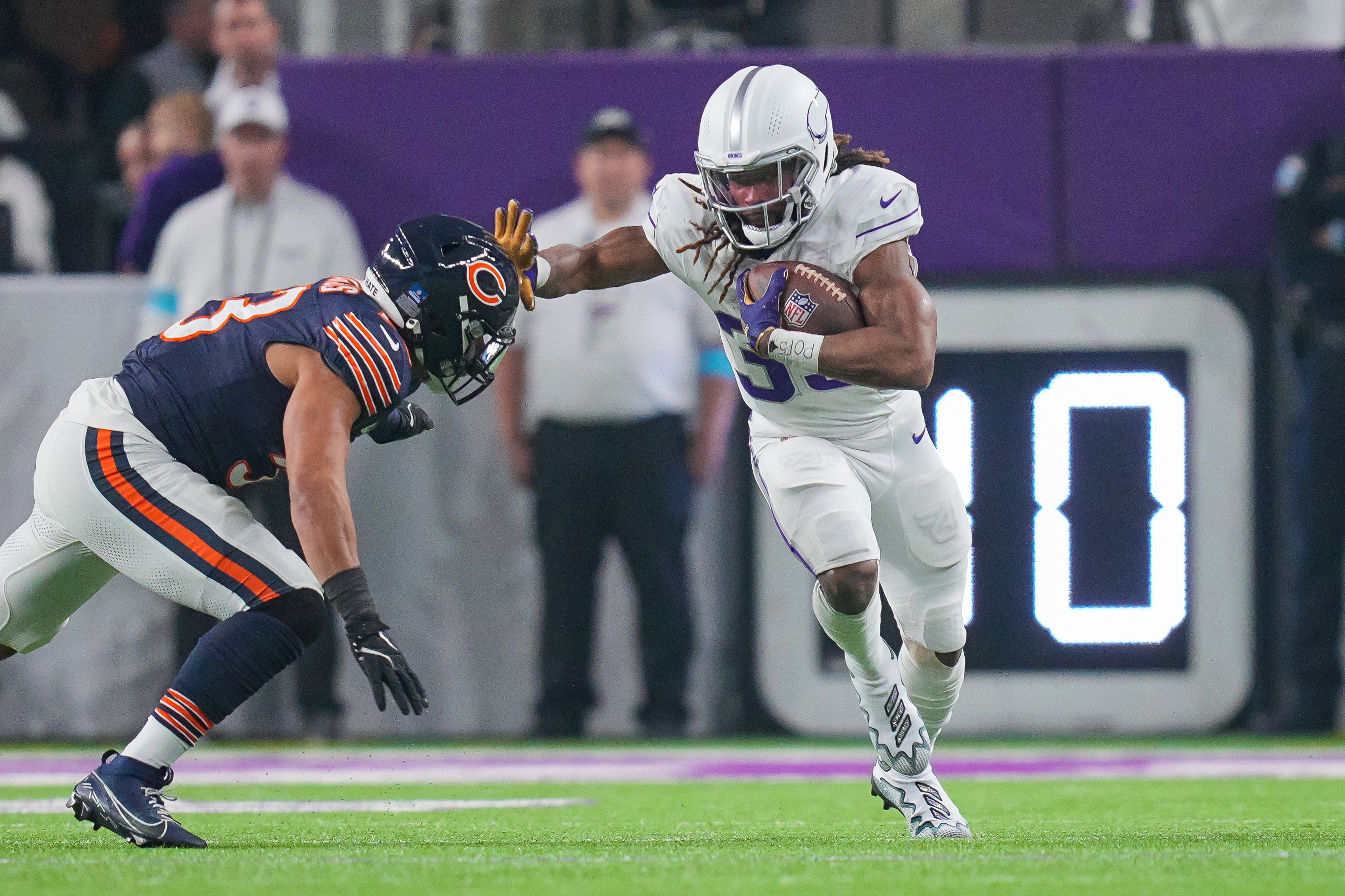 Dec 16, 2024; Minneapolis, Minnesota, USA; Minnesota Vikings running back Aaron Jones (33) runs with the ball against the Chicago Bears in the first quarter at U.S. Bank Stadium.