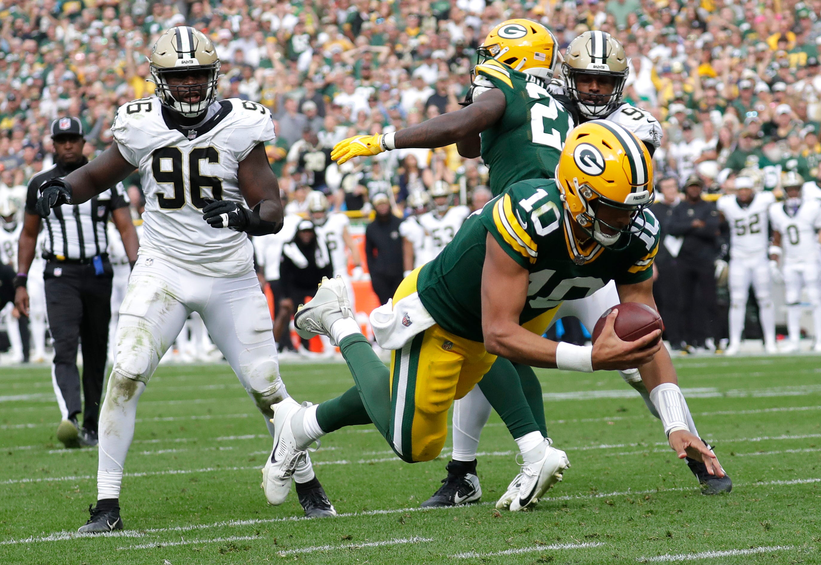 Green Bay Packers quarterback Jordan Love (10) dives for a touchdown against the New Orleans Saints in the fourth quarter during their football game Sunday, September 24, 2023, at Lambeau Field in Green Bay, Wis.