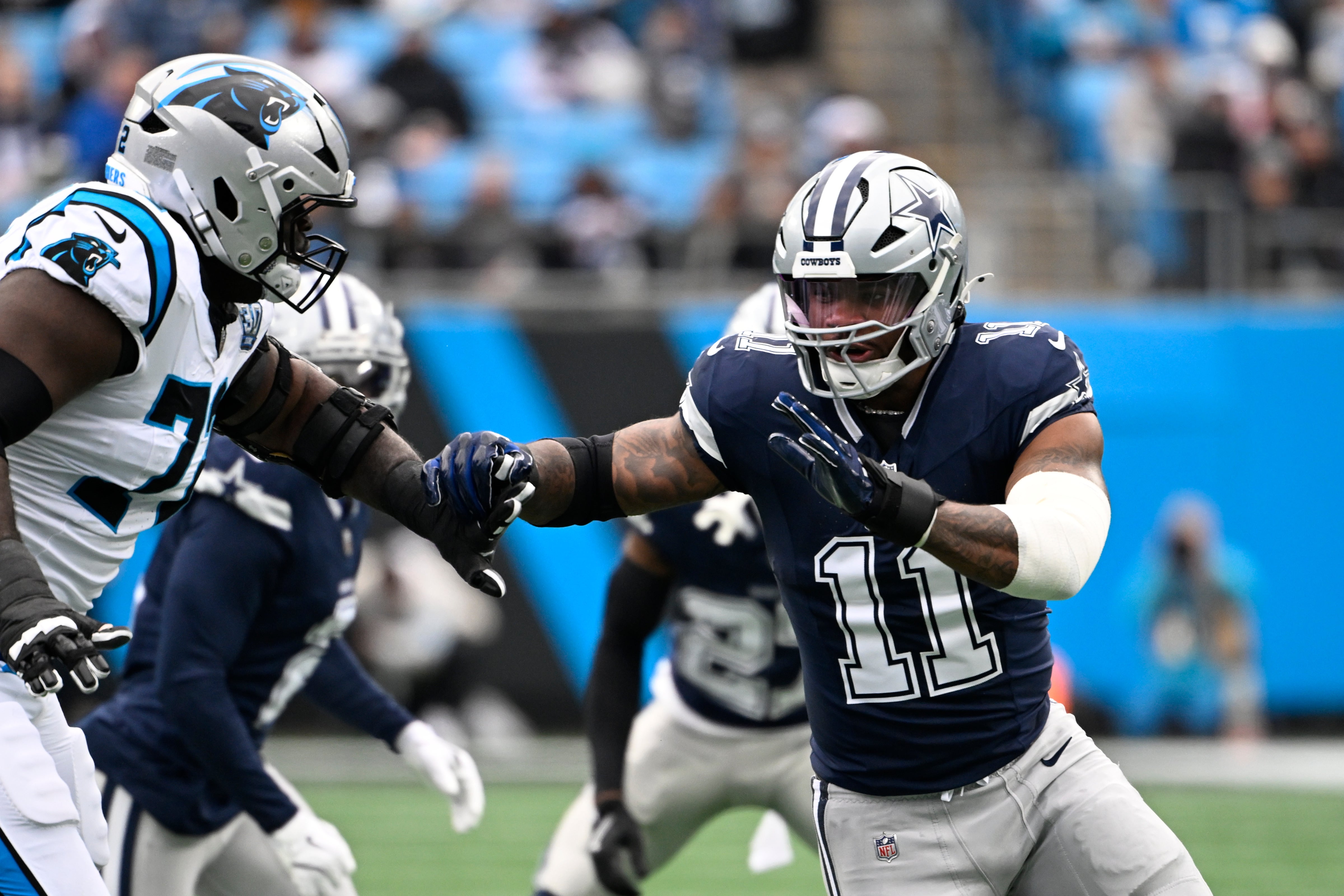 Dallas Cowboys linebacker Micah Parsons (11) rushes as Carolina Panthers offensive tackle Taylor Moton (72) defends in the first quarter at Bank of America Stadium.