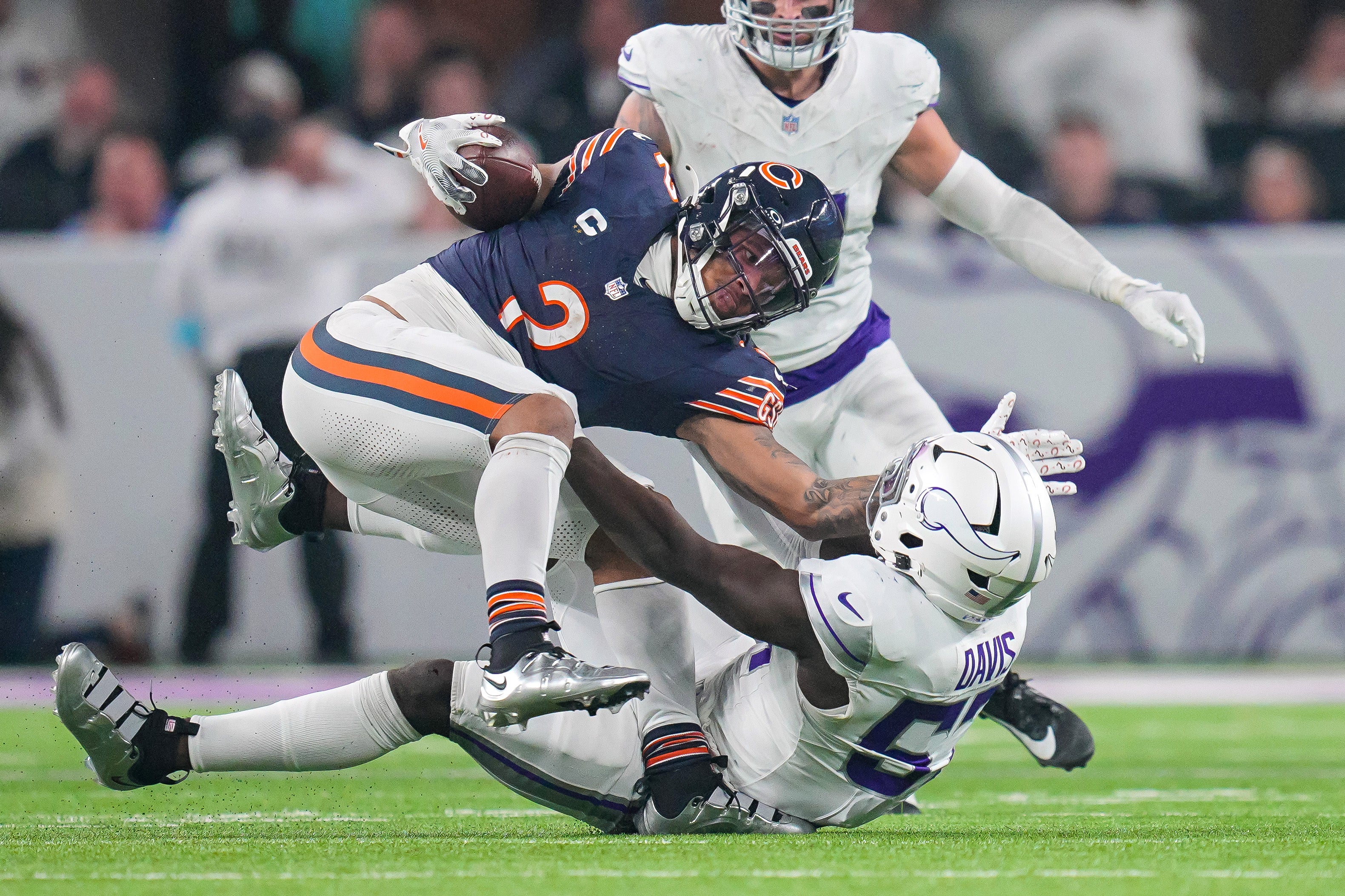 Dec 16, 2024; Minneapolis, Minnesota, USA; Chicago Bears wide receiver DJ Moore (2) is tackled by Minnesota Vikings linebacker Jamin Davis (57) in the third quarter at U.S. Bank Stadium.