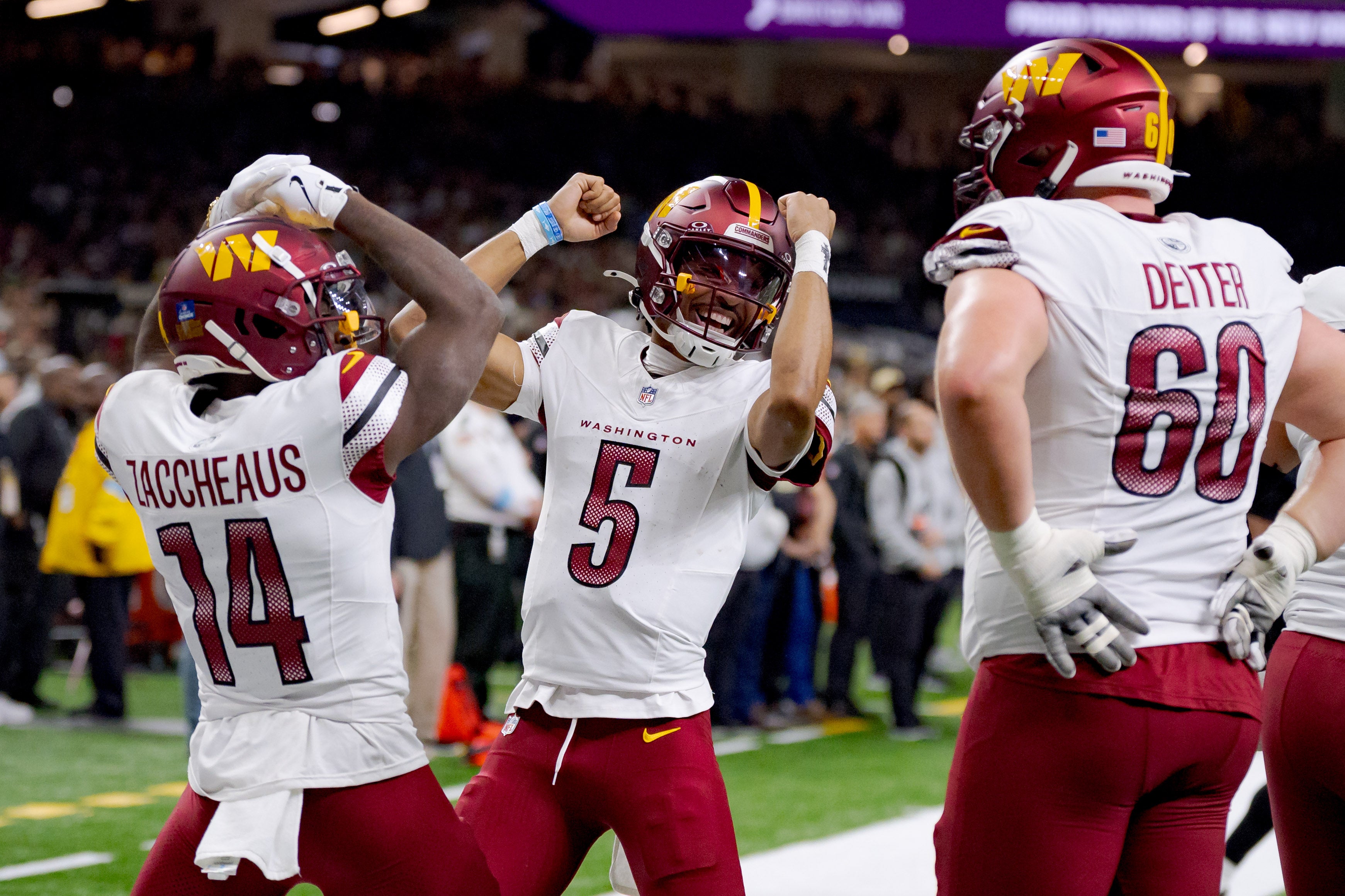 Dec 15, 2024; New Orleans, Louisiana, USA; Washington Commanders quarterback Jayden Daniels (5) and Washington Commanders wide receiver Olamide Zaccheaus (14) celebrate a touchdown against the New Orleans Saints that was later called off due to a penalty against Washington at Caesars Superdome.