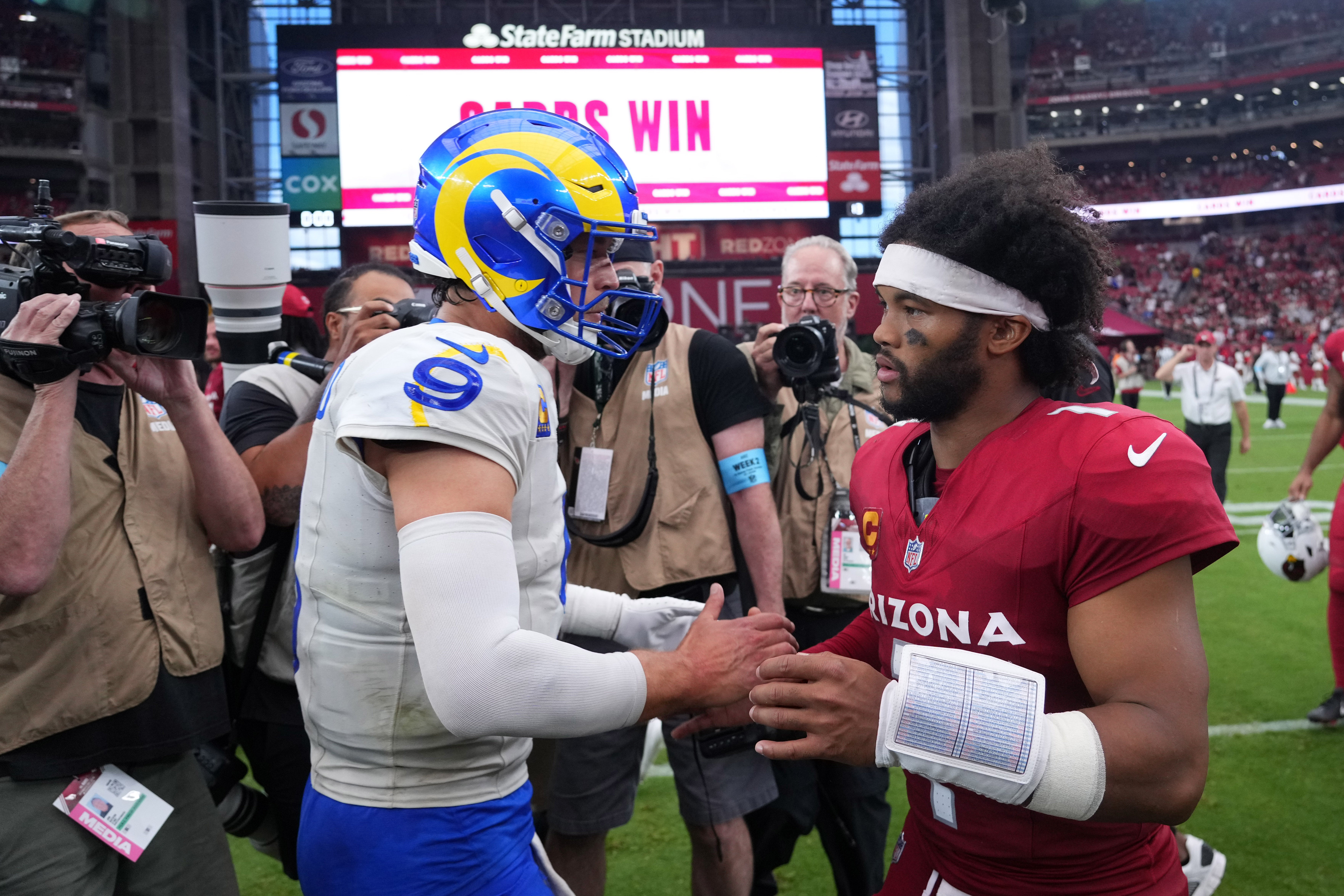 Los Angeles Rams quarterback Matthew Stafford (9) and Arizona Cardinals quarterback Kyler Murray (1) shake hands after the game at State Farm Stadium.
