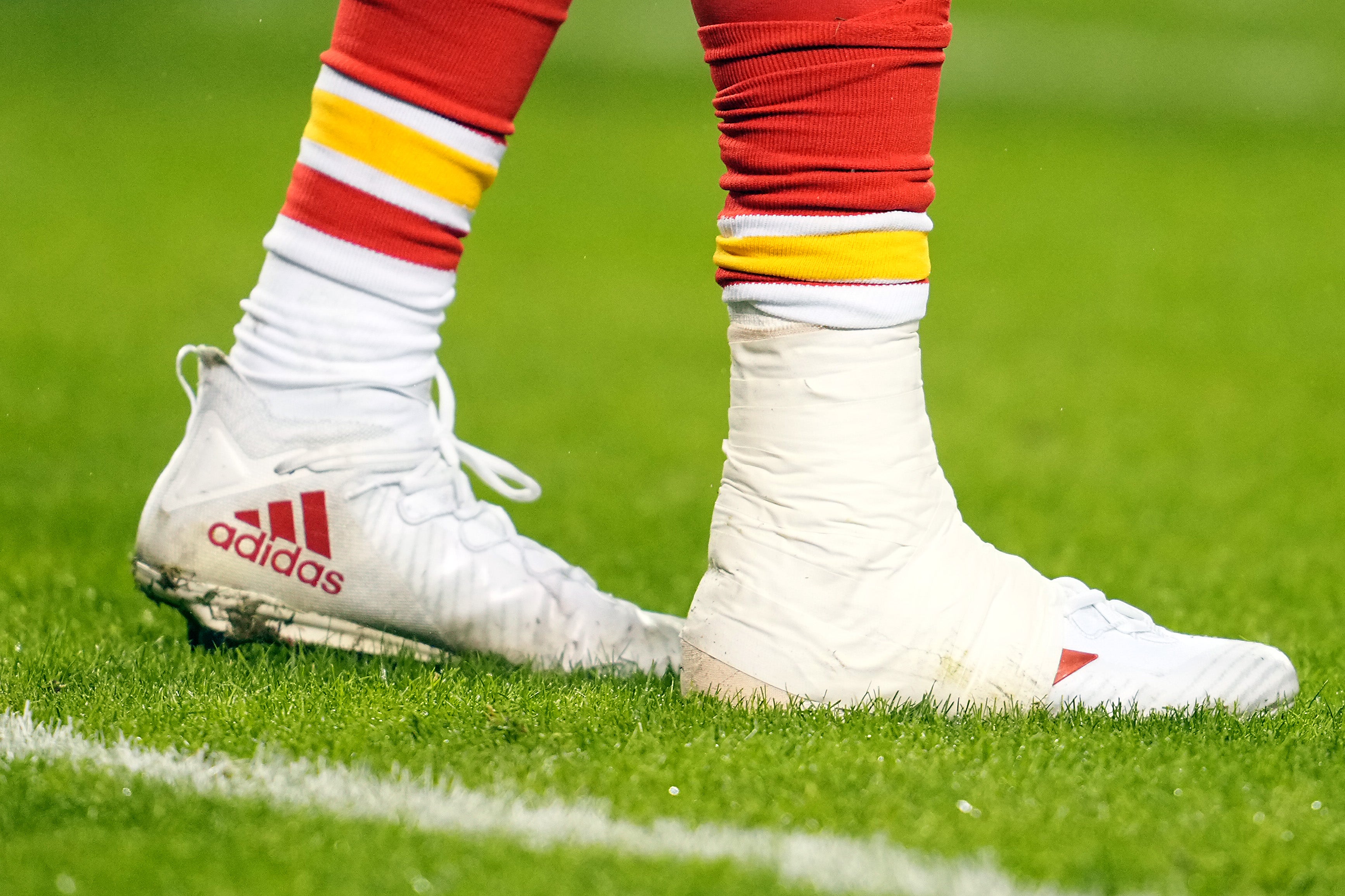 Jan 21, 2023; Kansas City, Missouri, USA; Kansas City Chiefs quarterback Patrick Mahomes (15) ankle is taped heavily during the second half in the AFC divisional round game at GEHA Field at Arrowhead Stadium.