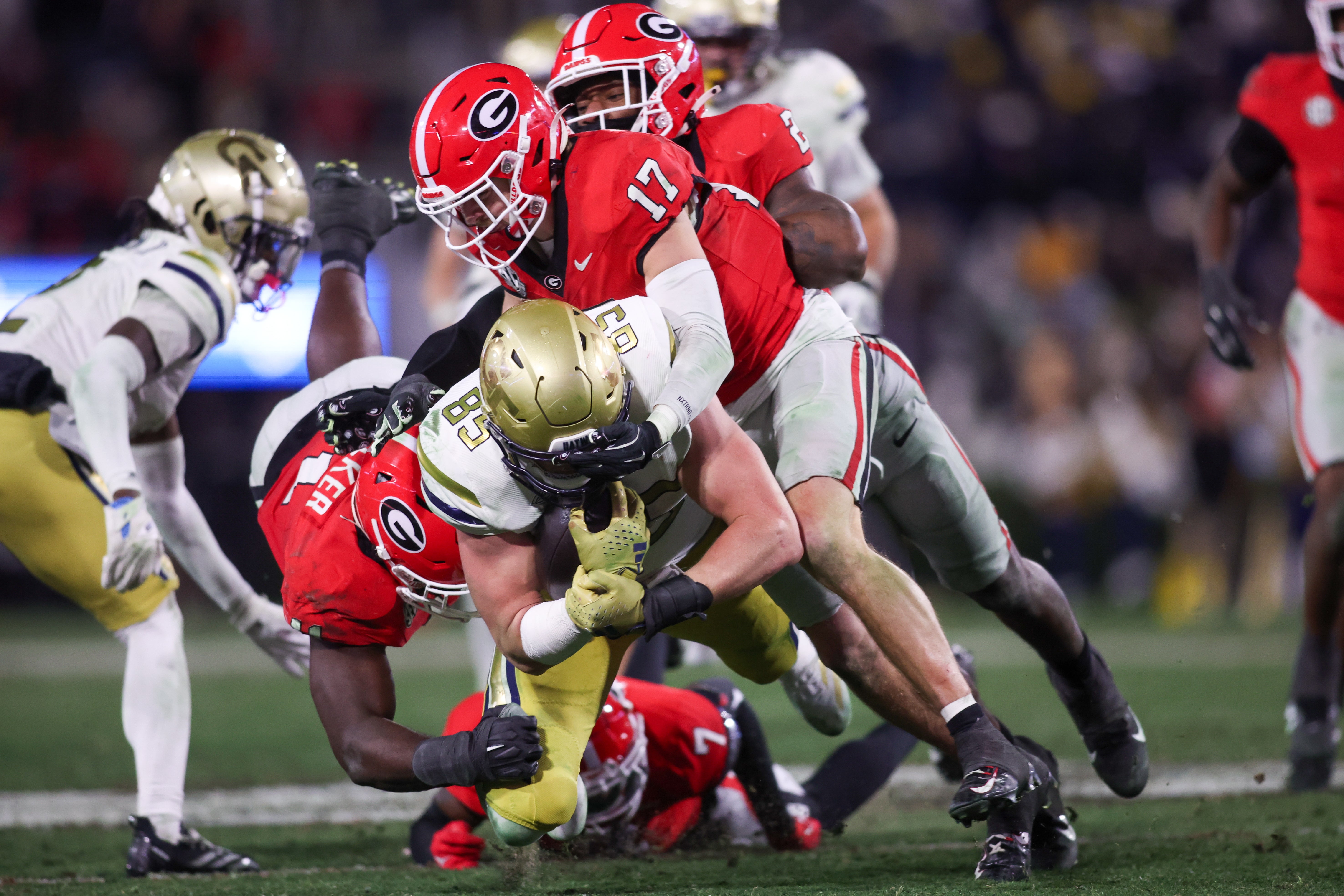 Georgia Tech Yellow Jackets tight end Jackson Hawes (85) is tackled by Georgia Bulldogs linebacker Jalon Walker (11) and defensive back Dan Jackson (17) in overtime at Sanford Stadium.