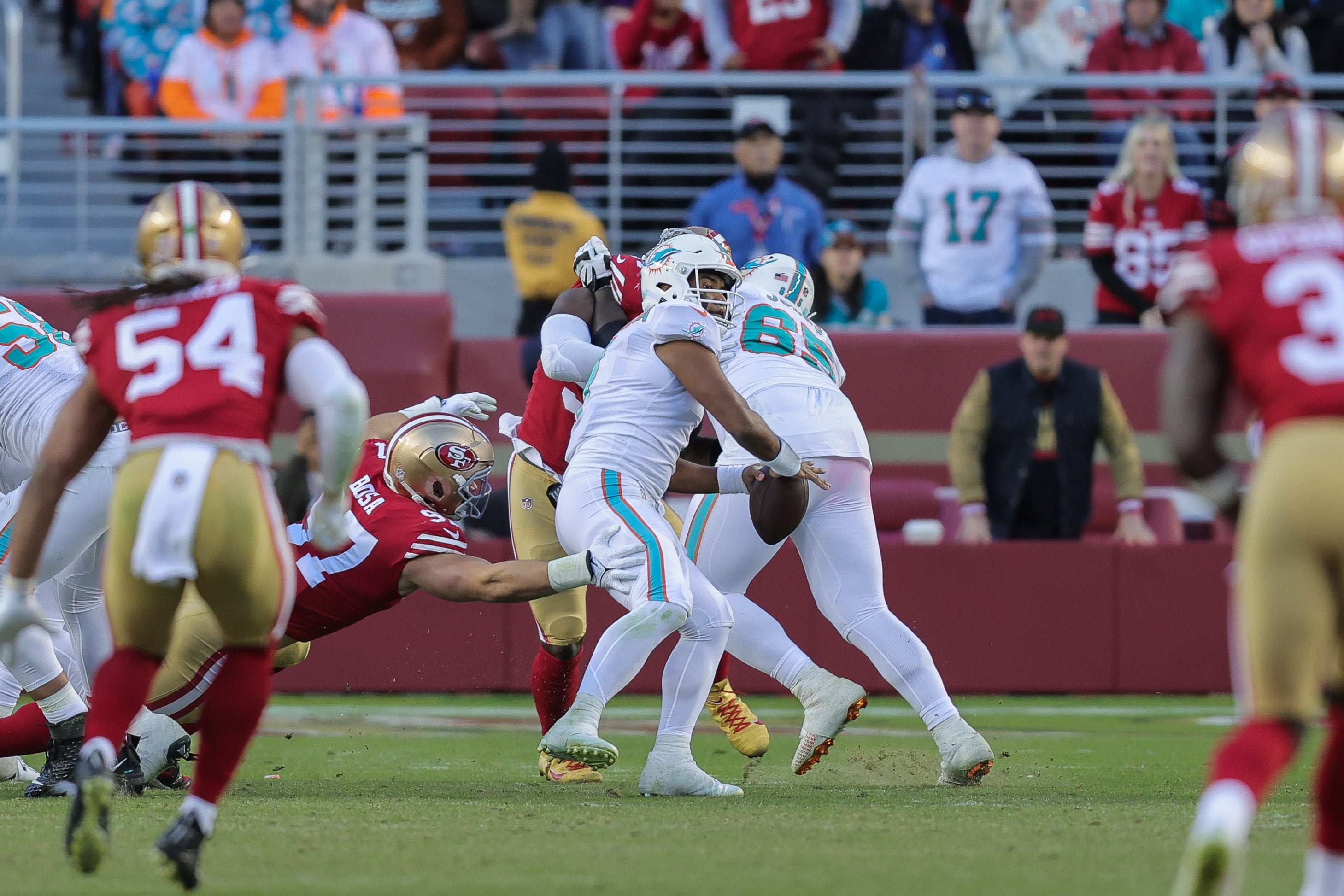 Miami Dolphins quarterback Tua Tagovailoa (1) is sacked by San Francisco 49ers defensive end Nick Bosa (97) and fumbles the ball during the fourth quarter at Levi's Stadium.
