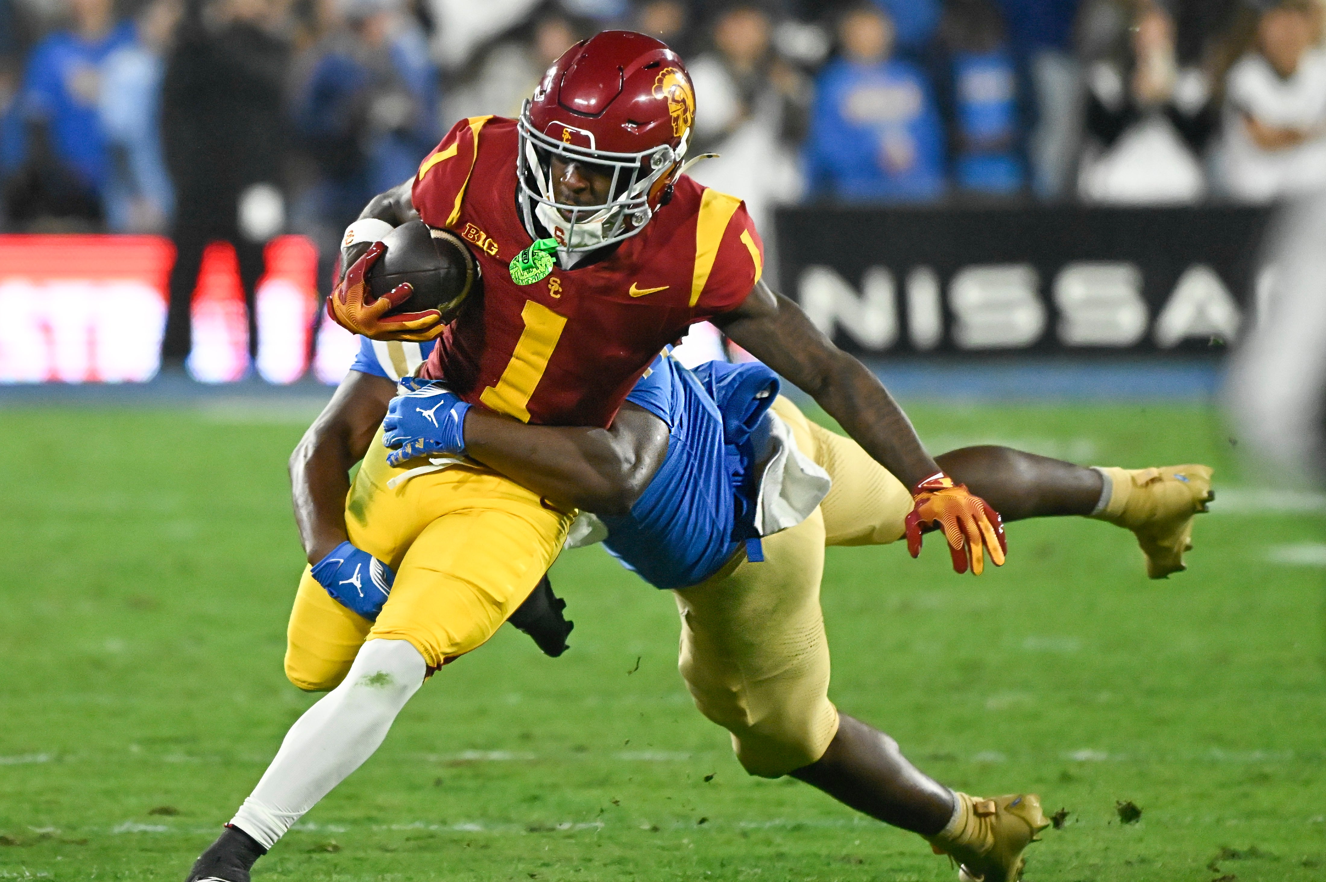 Nov 23, 2024; Pasadena, California, USA; USC Trojans wide receiver Zachariah Branch (1) is tackled by UCLA Bruins linebacker Jalen Woods (17) during the second quarter at Rose Bowl.