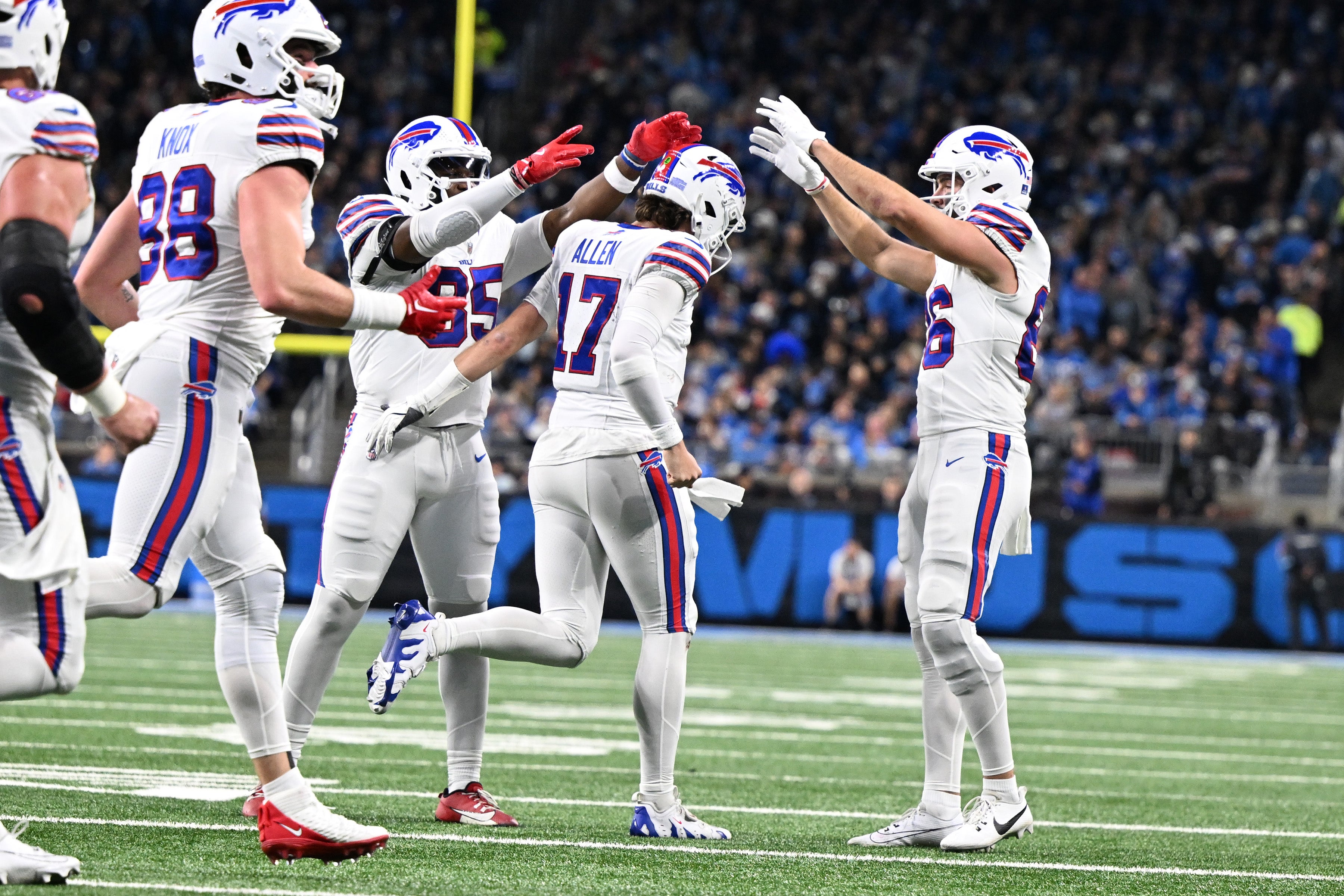 Bills quarterback Josh Allen (17) celebrates with tight end Quintin Morris (85) and tight end Dalton Kincaid (86) after scoring his second touchdown against the Lions.
