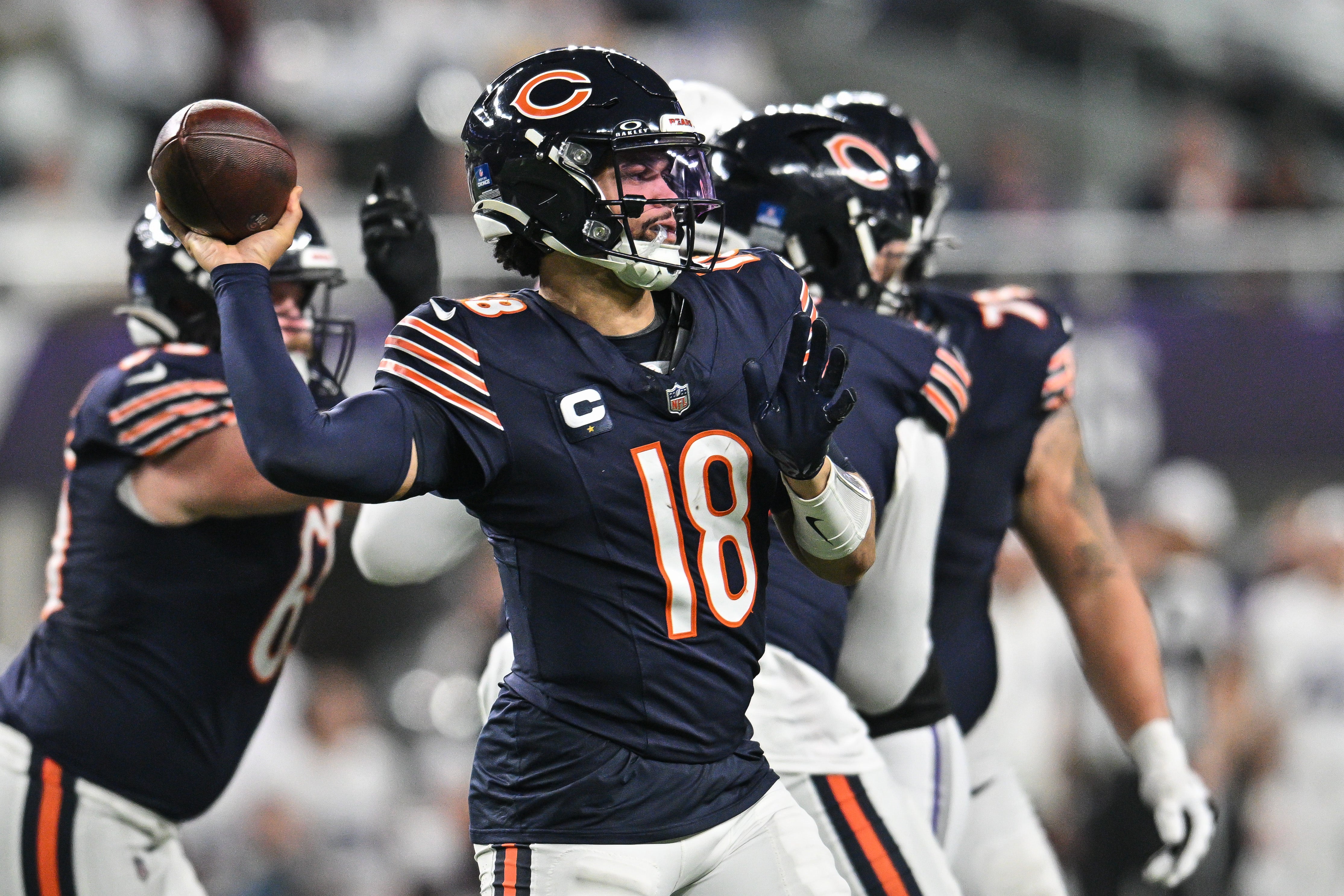 Dec 16, 2024; Minneapolis, Minnesota, USA; Chicago Bears quarterback Caleb Williams (18) throws a pass against the Minnesota Vikings during the fourth quarter at U.S. Bank Stadium.