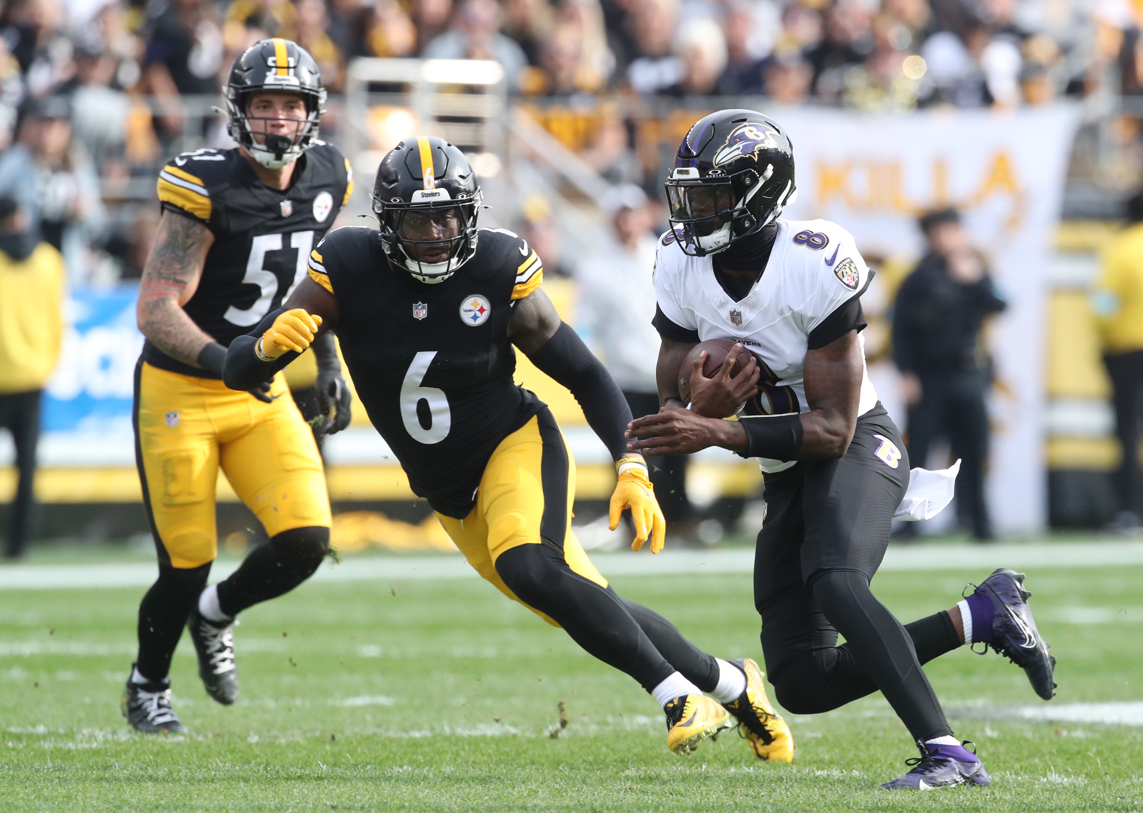 Nov 17, 2024; Pittsburgh, Pennsylvania, USA; Baltimore Ravens quarterback Lamar Jackson (8) runs the ball against Pittsburgh Steelers linebacker Patrick Queen (6) during the first quarter at Acrisure Stadium.