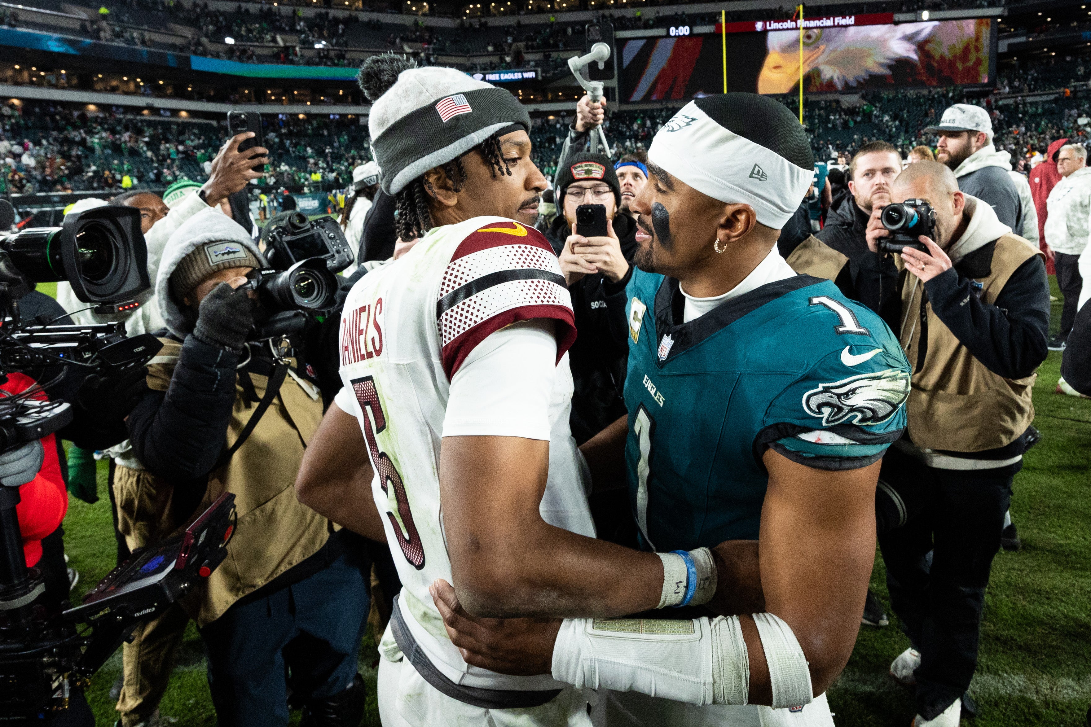 Philadelphia Eagles quarterback Jalen Hurts (1) and Washington Commanders quarterback Jayden Daniels (5) shake hands after an Eagles victory at Lincoln Financial Field.
