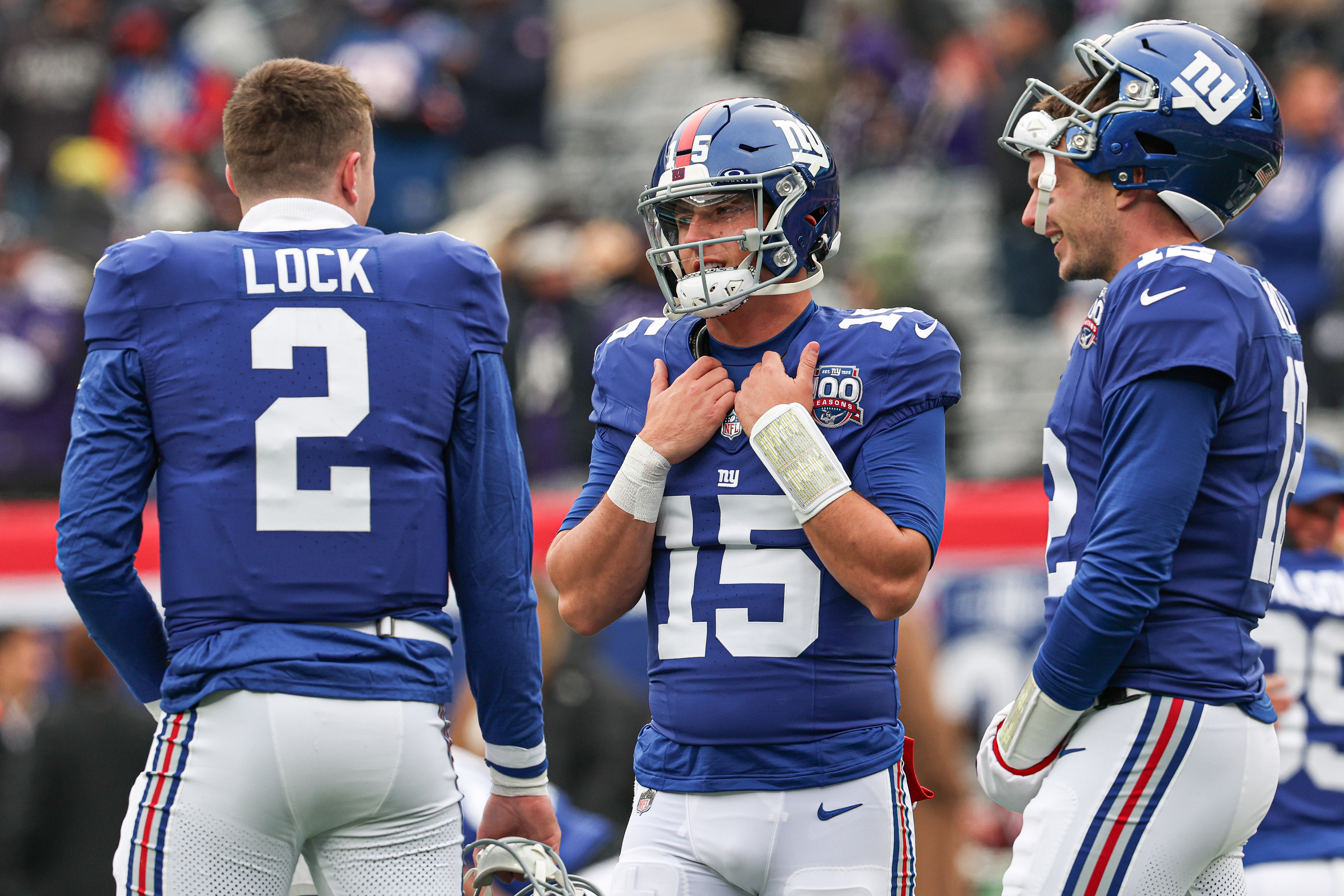 New York Giants quarterback Tommy DeVito (15) talks with quarterback Drew Lock (2) and quarterback Drew Lock (2) before the game against the Baltimore Ravens at MetLife Stadium.