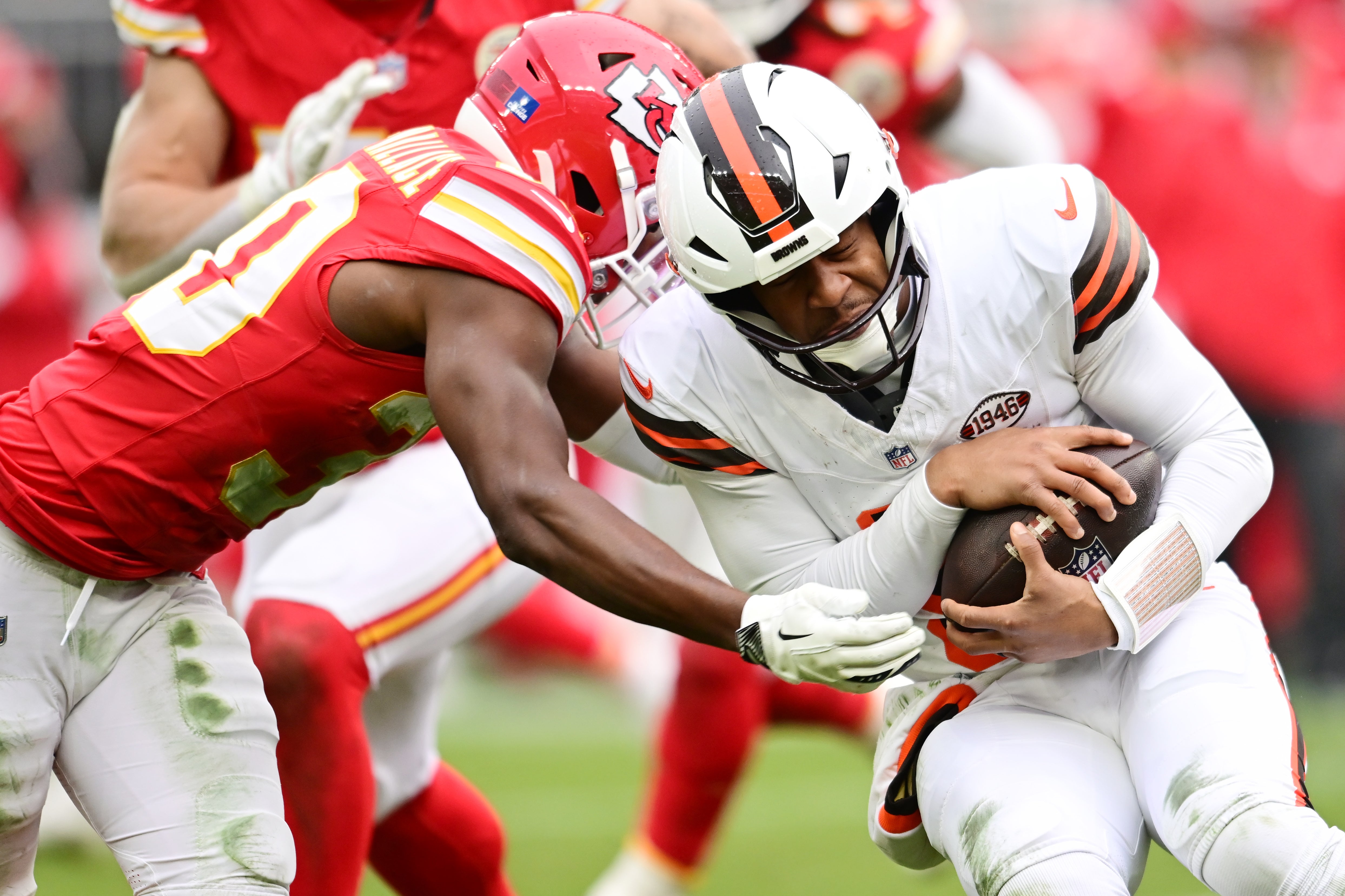 Dec 15, 2024; Cleveland, Ohio, USA; Kansas City Chiefs cornerback Christian Roland-Wallace (30) tackles Cleveland Browns quarterback Jameis Winston (5) during the second half at Huntington Bank Field.