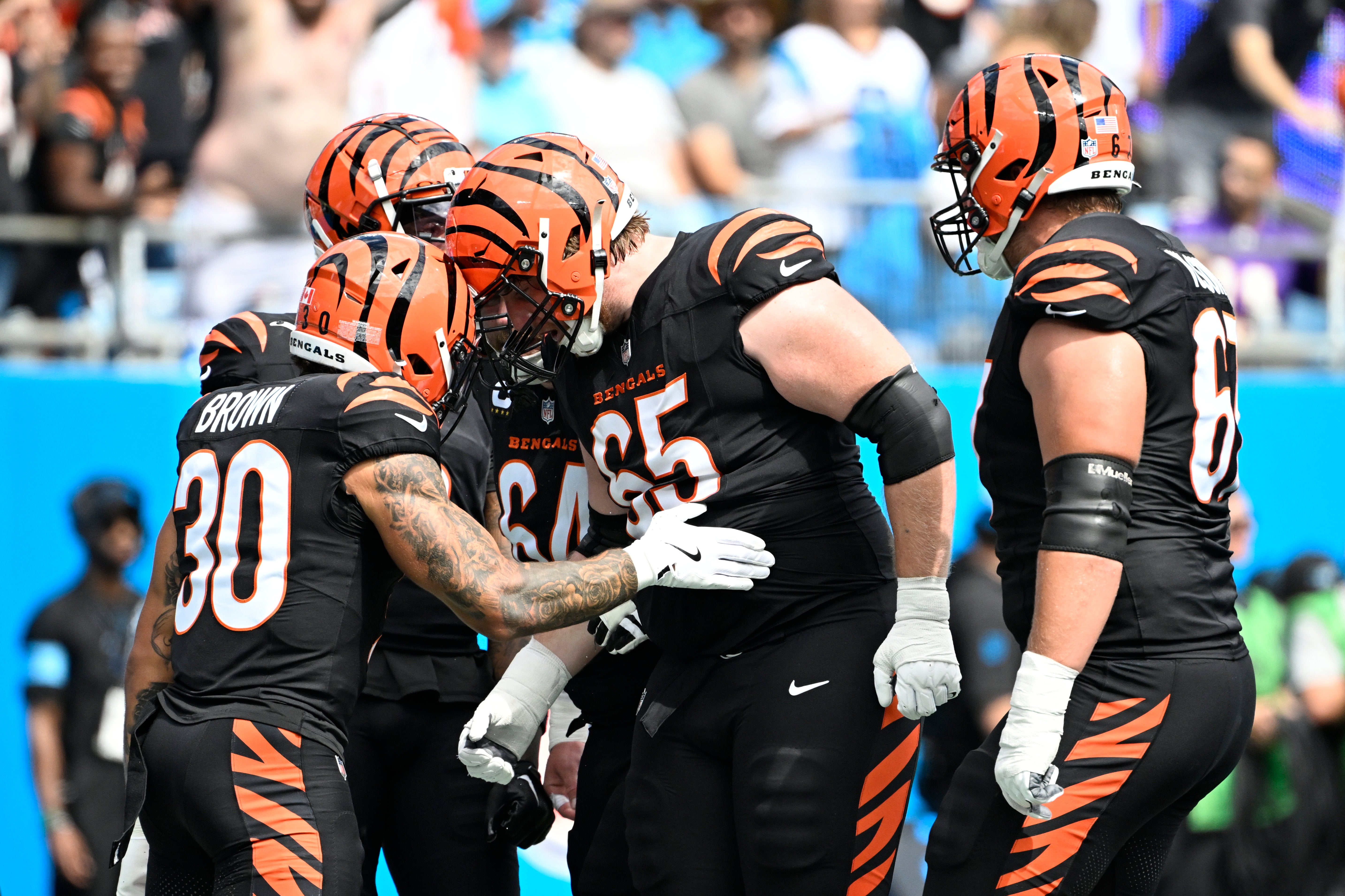 Sep 29, 2024; Charlotte, North Carolina, USA; Cincinnati Bengals running back Chase Brown (30) celebrates with guard Alex Cappa (65) after scoring a touchdown in the first quarter at Bank of America Stadium.